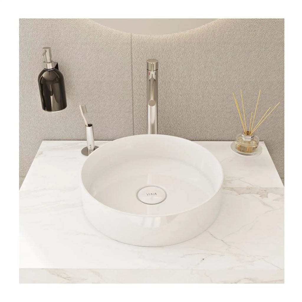 Sleek white ceramic bathroom sink with modern chrome fixtures on a marble countertop, set against neutral textured wall tiles, perfect for contemporary Bubly bathrooms.