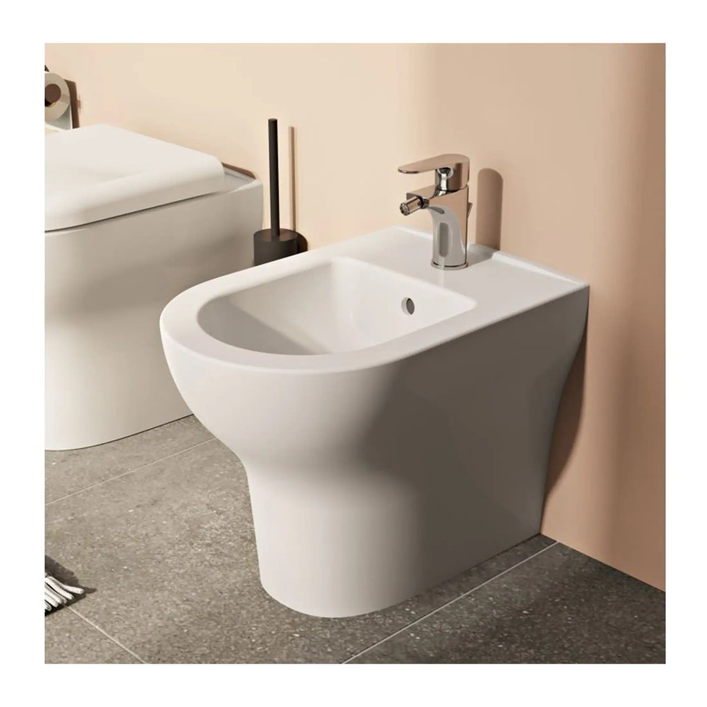 Sleek white bathroom bidet with modern chrome tap, ideal for contemporary bathroom renovation and fittings. Perfect for hygiene and comfort in modern bathrooms.