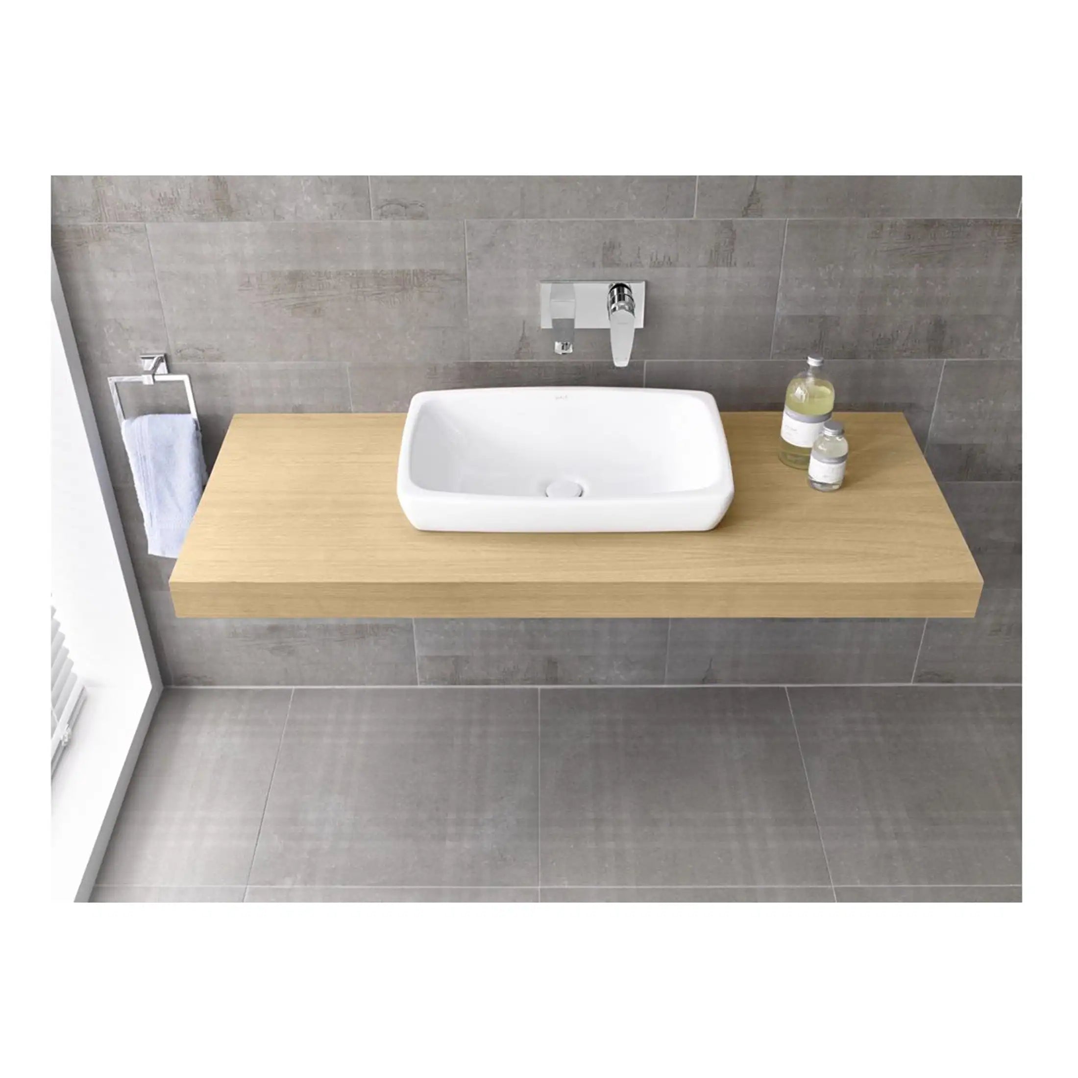 Sleek modern bathroom vanity with a white rectangular sink mounted on a floating wooden countertop, set against grey tiled walls and floor, featuring minimalist fixtures and accessories.