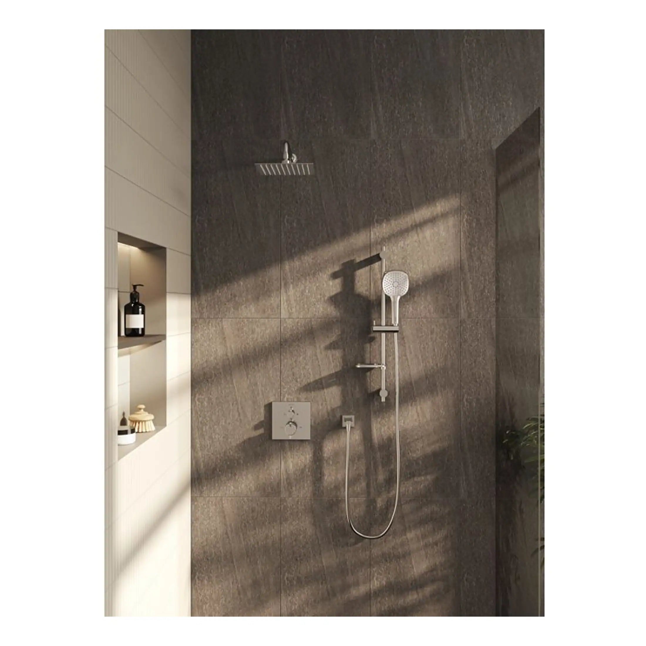 Modern walk-in shower with rain showerhead and handheld shower, featuring sleek grey tile walls and built-in niche for toiletries at Bubly Bathrooms.