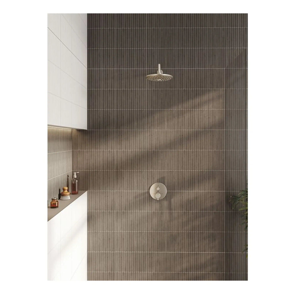 Shower area with modern rainfall showerhead and brown textured tiles, sleek white bathroom cabinetry, and minimal decor, creating a contemporary and stylish bathroom design.