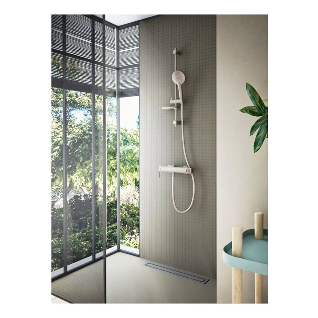 Modern walk-in shower with grey tiled wall and ceiling-to-floor glass window, featuring white shower fixtures, in contemporary bathroom design.