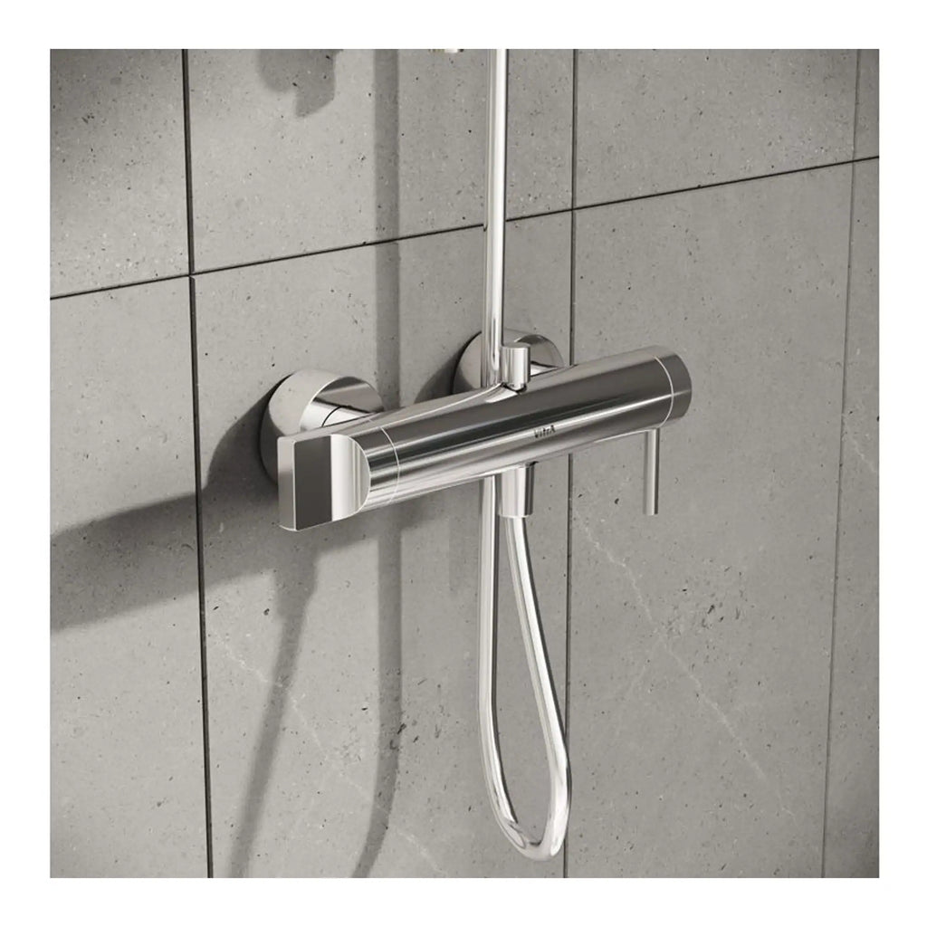 Shower mixing valve with handheld showerhead installed on grey tiled wall, modern bathroom fixture, chrome finish, Bubly Bathrooms.