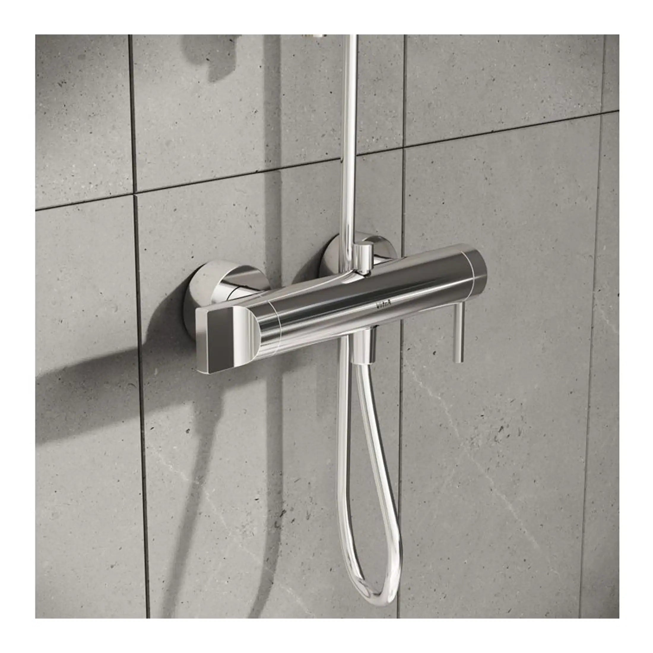 Shower mixing valve with handheld showerhead installed on grey tiled wall, modern bathroom fixture, chrome finish, Bubly Bathrooms.