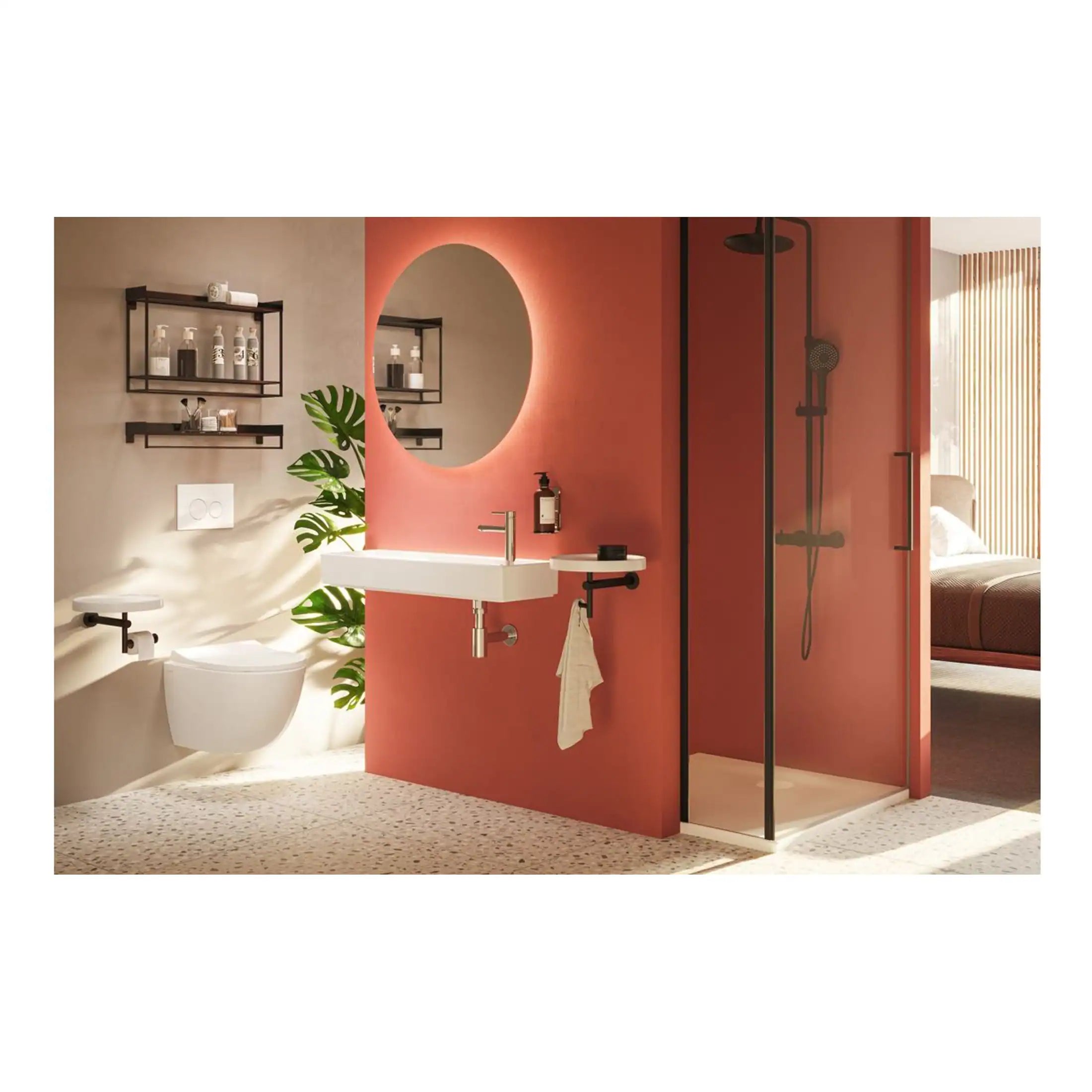 Contemporary bathroom with walk-in shower, wall-mounted toilet, stylish vanity with round mirror, and modern black fixtures in a sleek, minimalist design featuring soft pink and neutral tones.