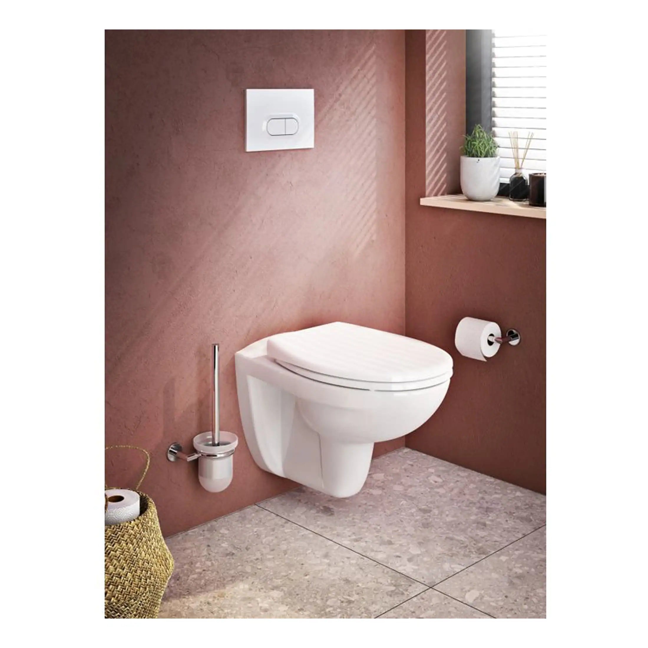 Sleek modern wall-mounted toilet with a concealed cistern and minimalist design, set in a stylish bathroom with soft pink walls and contemporary decor. Perfect for enhancing bathroom aesthetics.