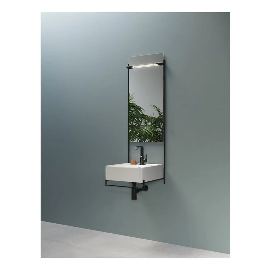 Modern wall-mounted bathroom sink with a tall mirror and sleek black frame, ideal for contemporary Bubly bathrooms focusing on minimalist design and space efficiency.
