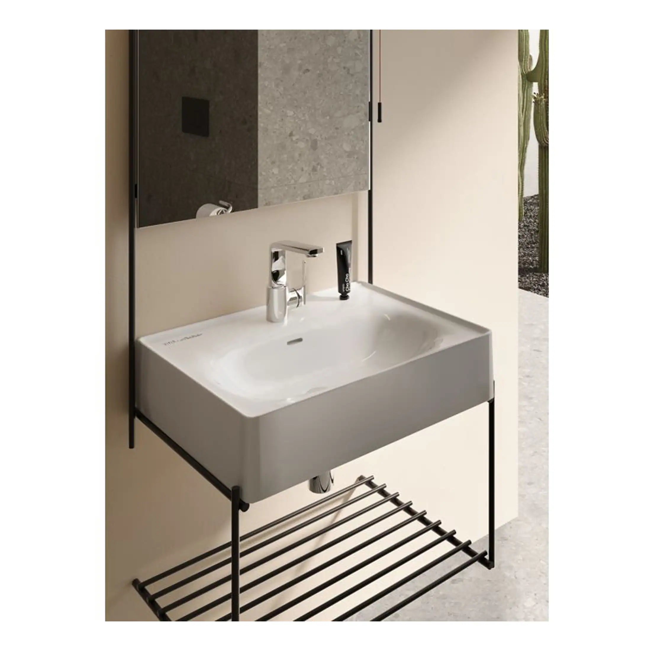 Contemporary bathroom sink with sleek white basin, modern chrome tap, and black metal frame including a lower rack for storage, ideal for stylish bathroom interiors.