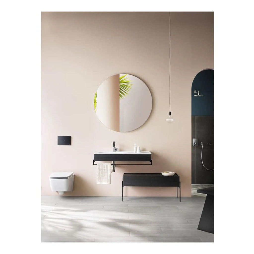 Sleek modern bathroom with minimalist design, featuring a black and white floating vanity, round mirror, wall-mounted toilet, and open shower area for a contemporary aesthetic.
