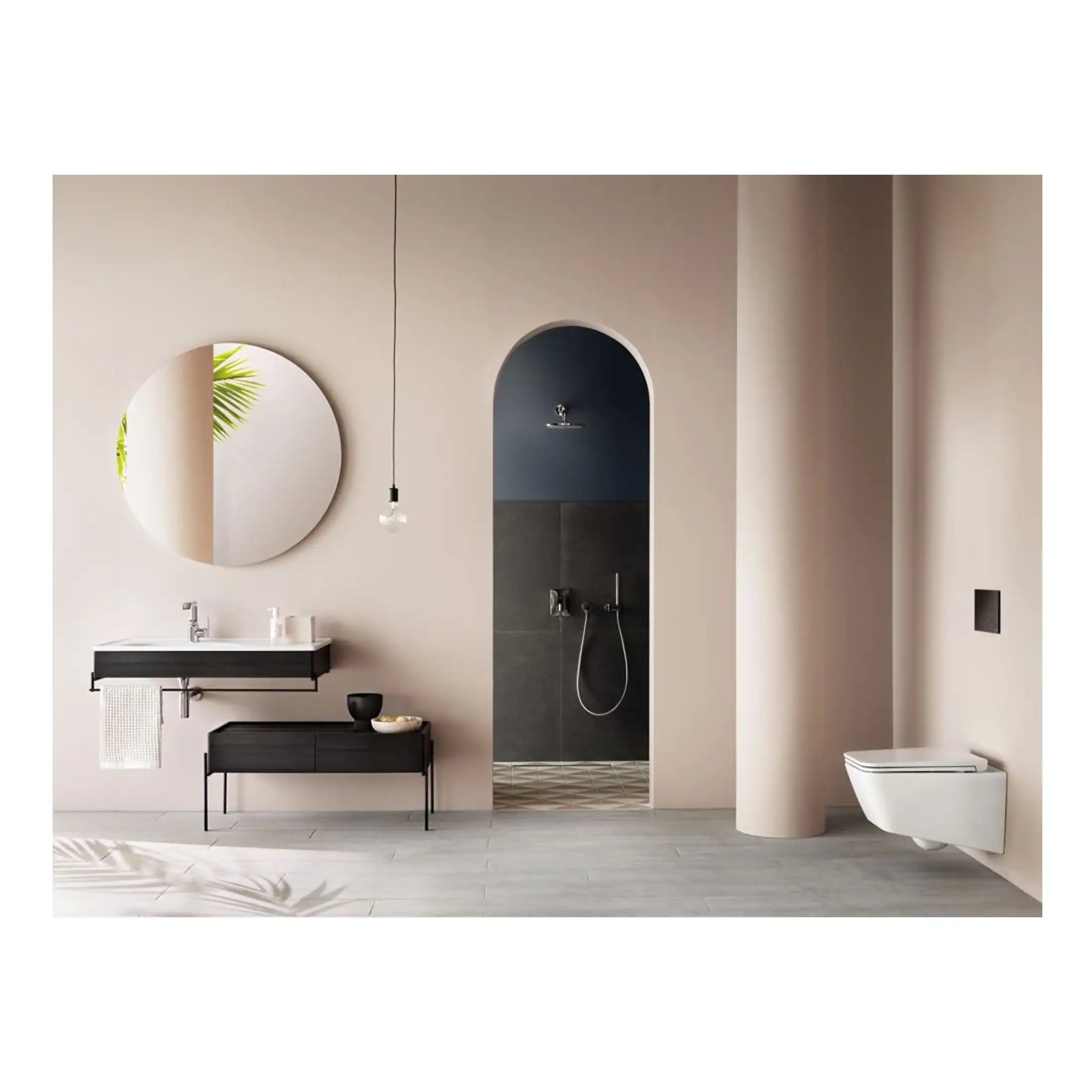 Sleek modern bathroom with a stylish wall-mounted sink, large round mirror, walk-in shower featuring dark tiles, and contemporary toilet, all designed with minimalist aesthetics.