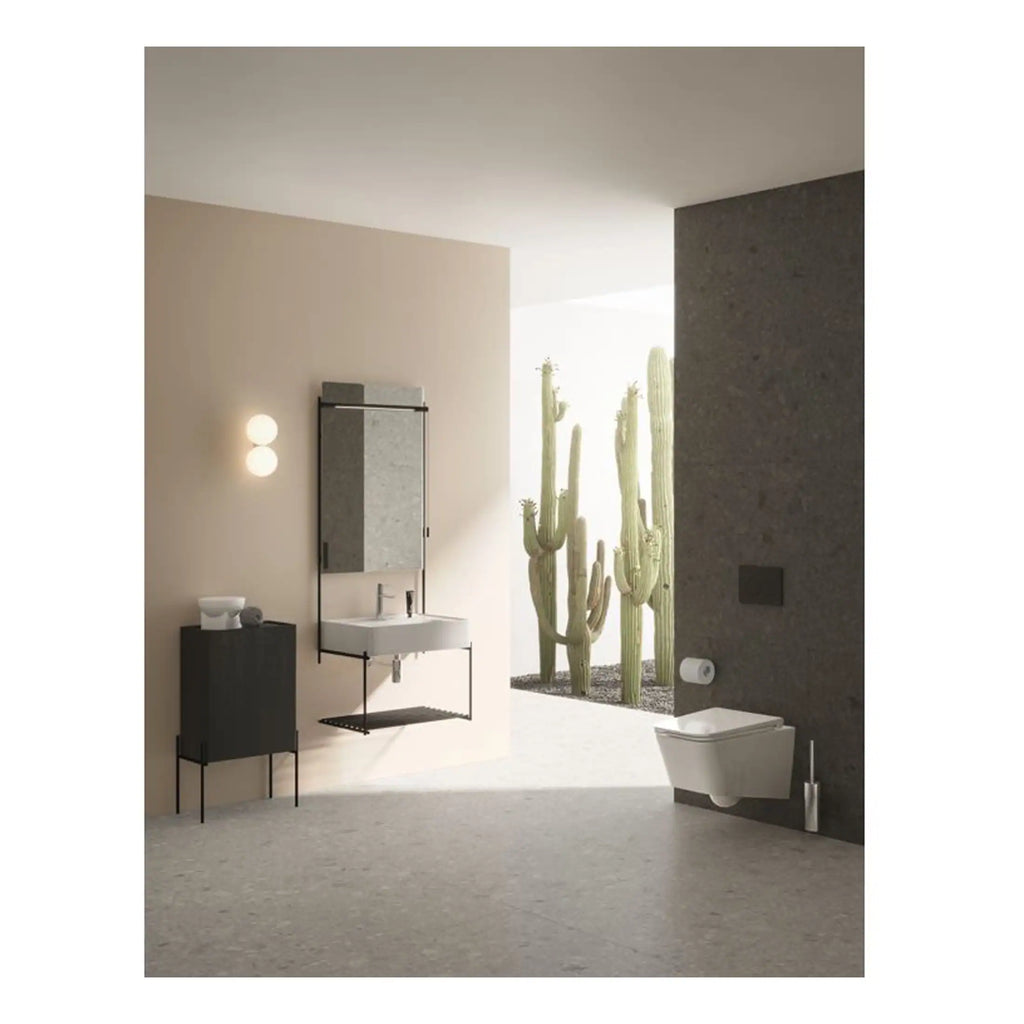 Sleek modern bathroom with minimalist fixtures, beige and dark grey walls, wall-mounted sink, and cactus plants outside, creating a stylish and contemporary space.
