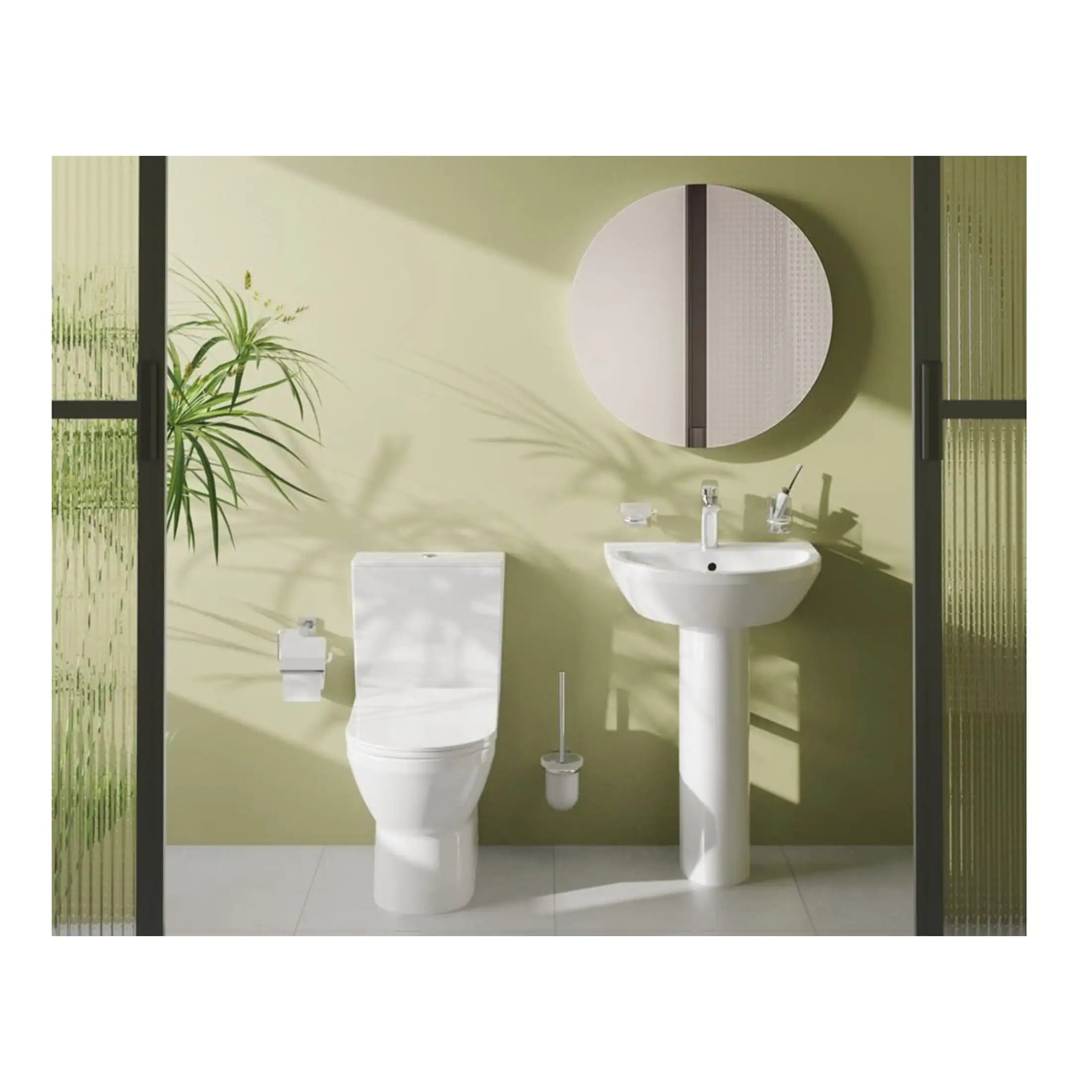 Sleek white toilet and pedestal sink in modern bathroom with green wall, round mirror, and decorative glass sliding doors featuring contemporary design elements.