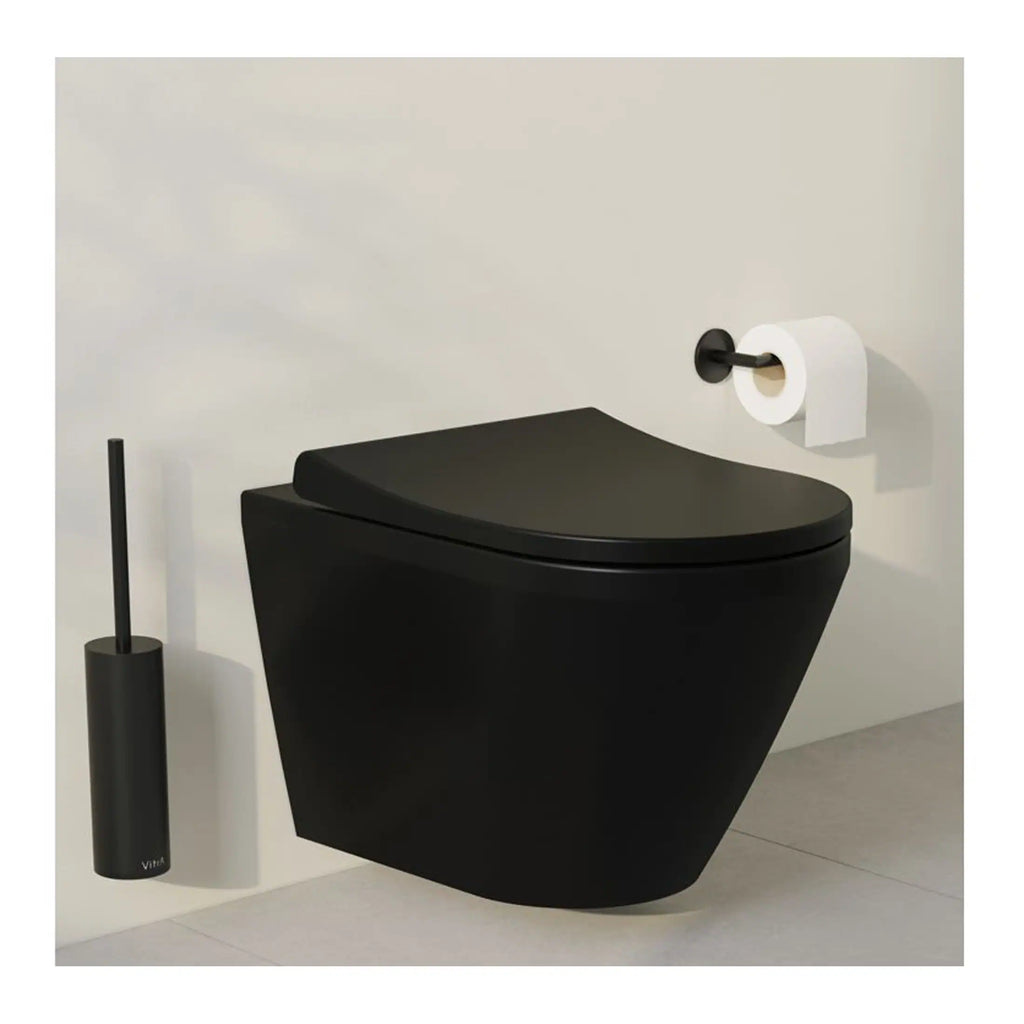 Black modern wall-mounted toilet with sleek design and matching black toilet brush holder, minimalist bathroom setup with white wall and grey floor.