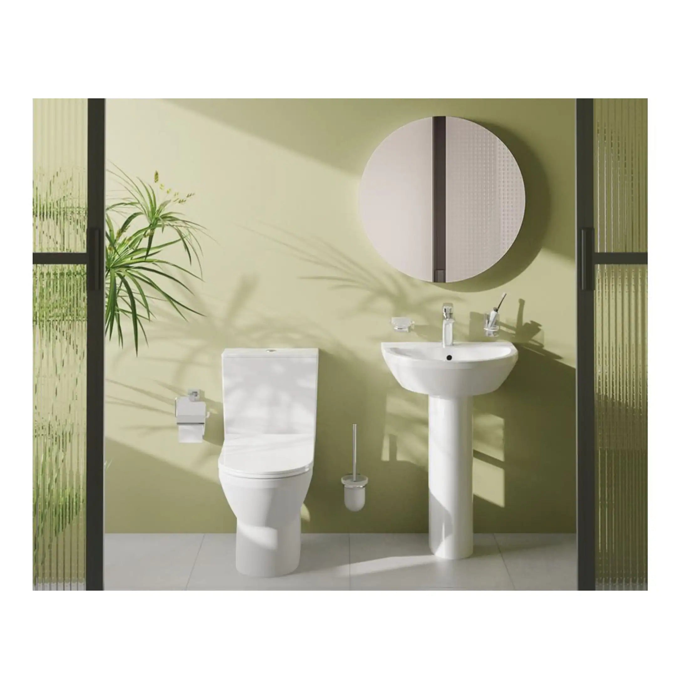 Modern bathroom with white toilet and pedestal sink, round mirror, green wall, and glass doors, showcasing contemporary bathroom fixtures and stylish interior design.
