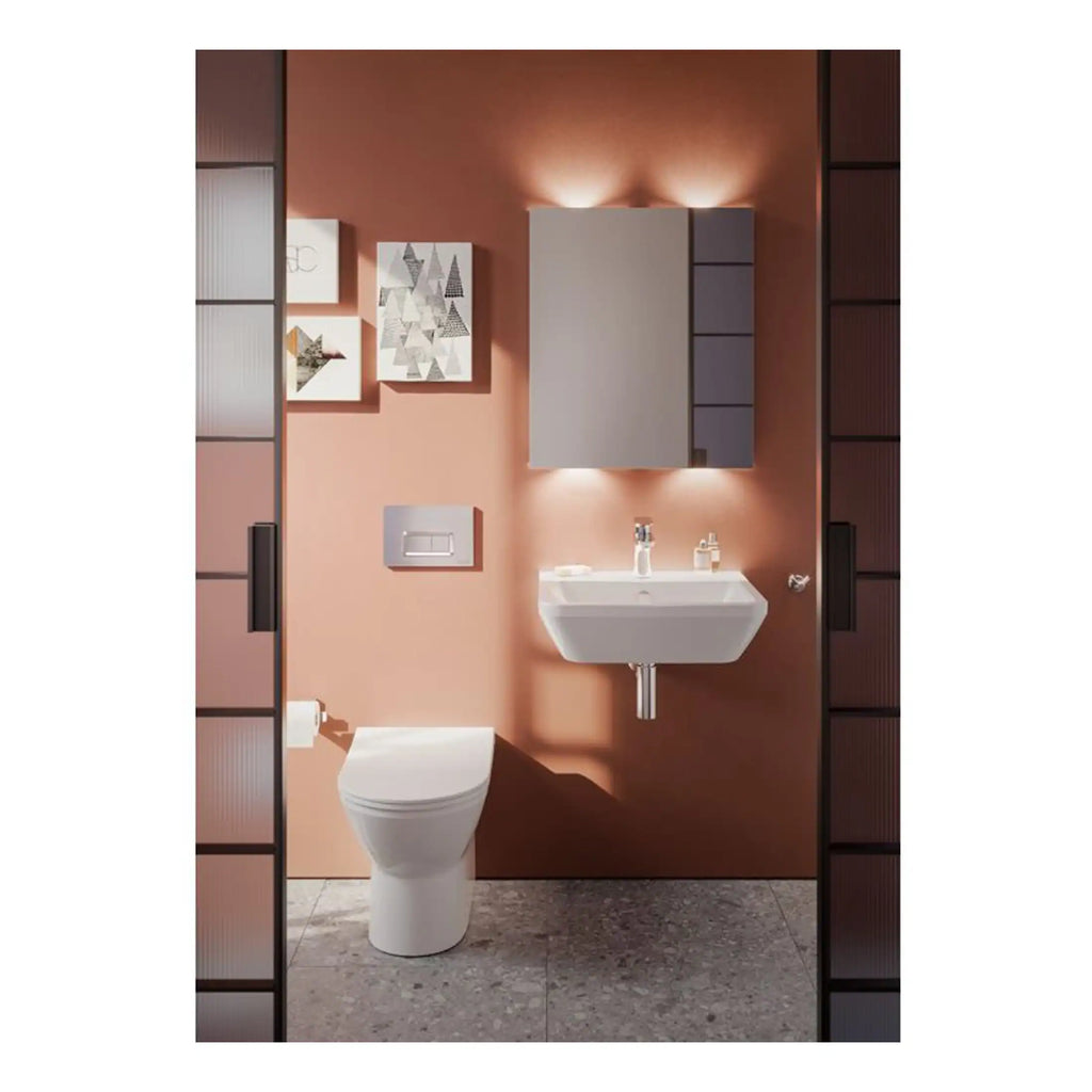 Sleek modern bathroom featuring a wall-mounted sink, contemporary toilet, mirrored cabinet, and decorative wall art, designed for stylish comfort and functionality.