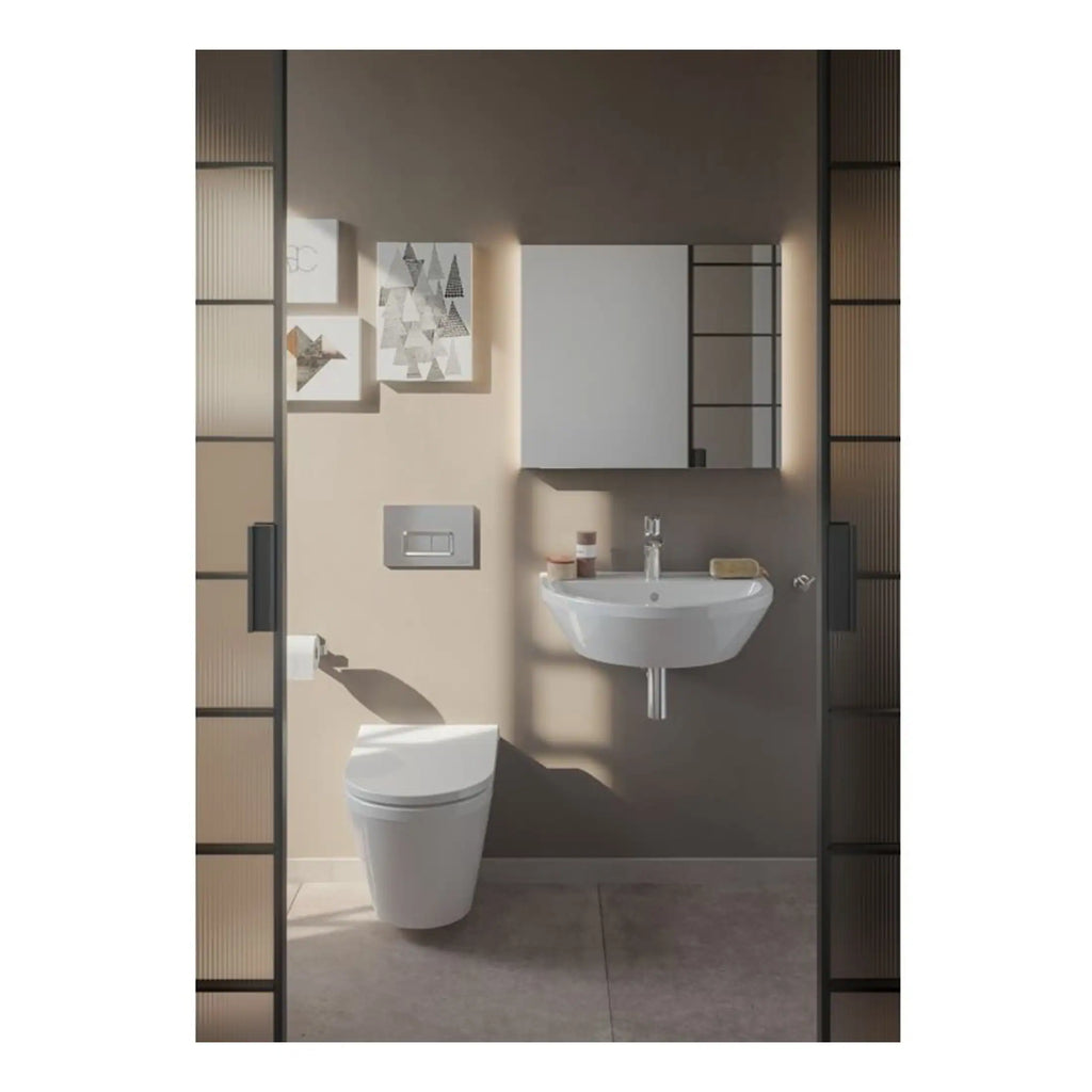 Modern compact bathroom with wall-mounted toilet and a sleek corner sink, featuring minimalist design and neutral colour palette.