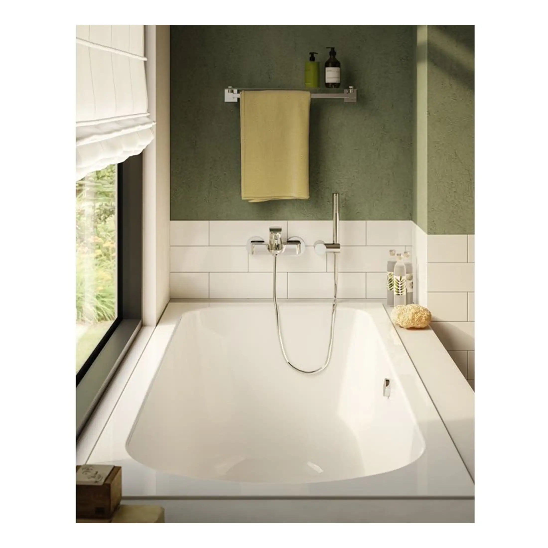 Bright white bathtub with modern chrome fixtures in a contemporary bathroom with green textured walls and natural light.