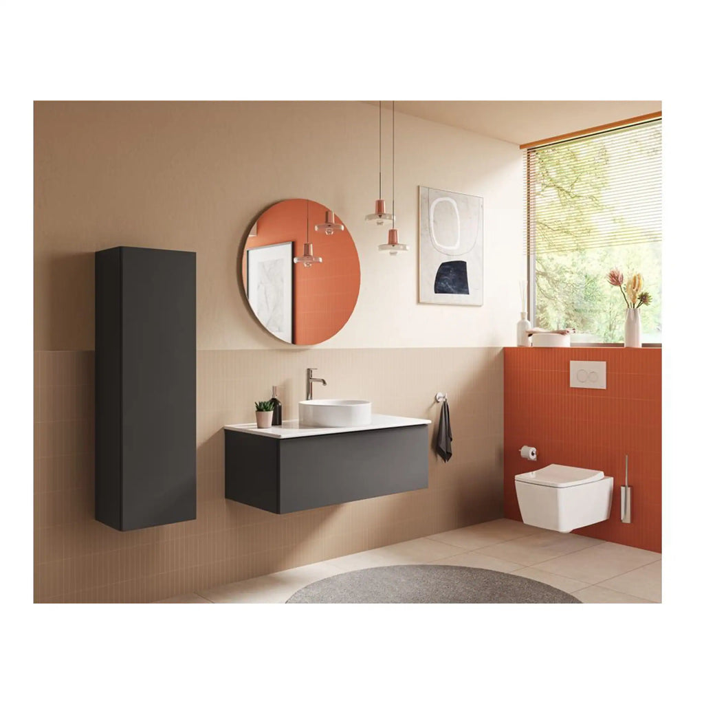 Modern bathroom with sleek black storage units, wall-mounted toilet, contemporary sink, round mirror, and stylish decor, featuring natural light and warm tones for a chic, functional space.