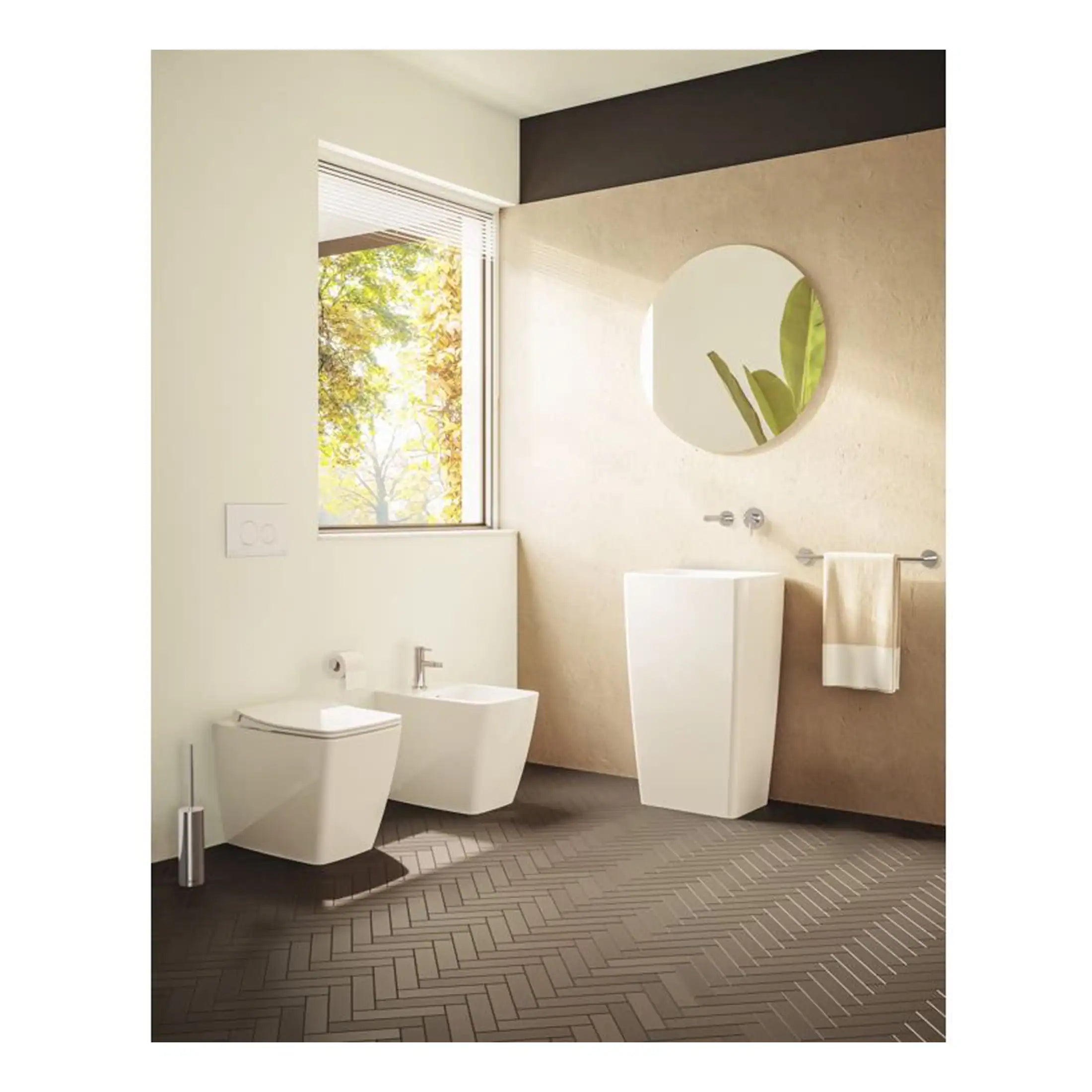 Sleek modern bathroom with open-concept white wall-hung toilet and bidet, minimalist tall ceramic wash basin, and stylish round mirror, illuminated by natural light from a large window, creating a bright, airy space.