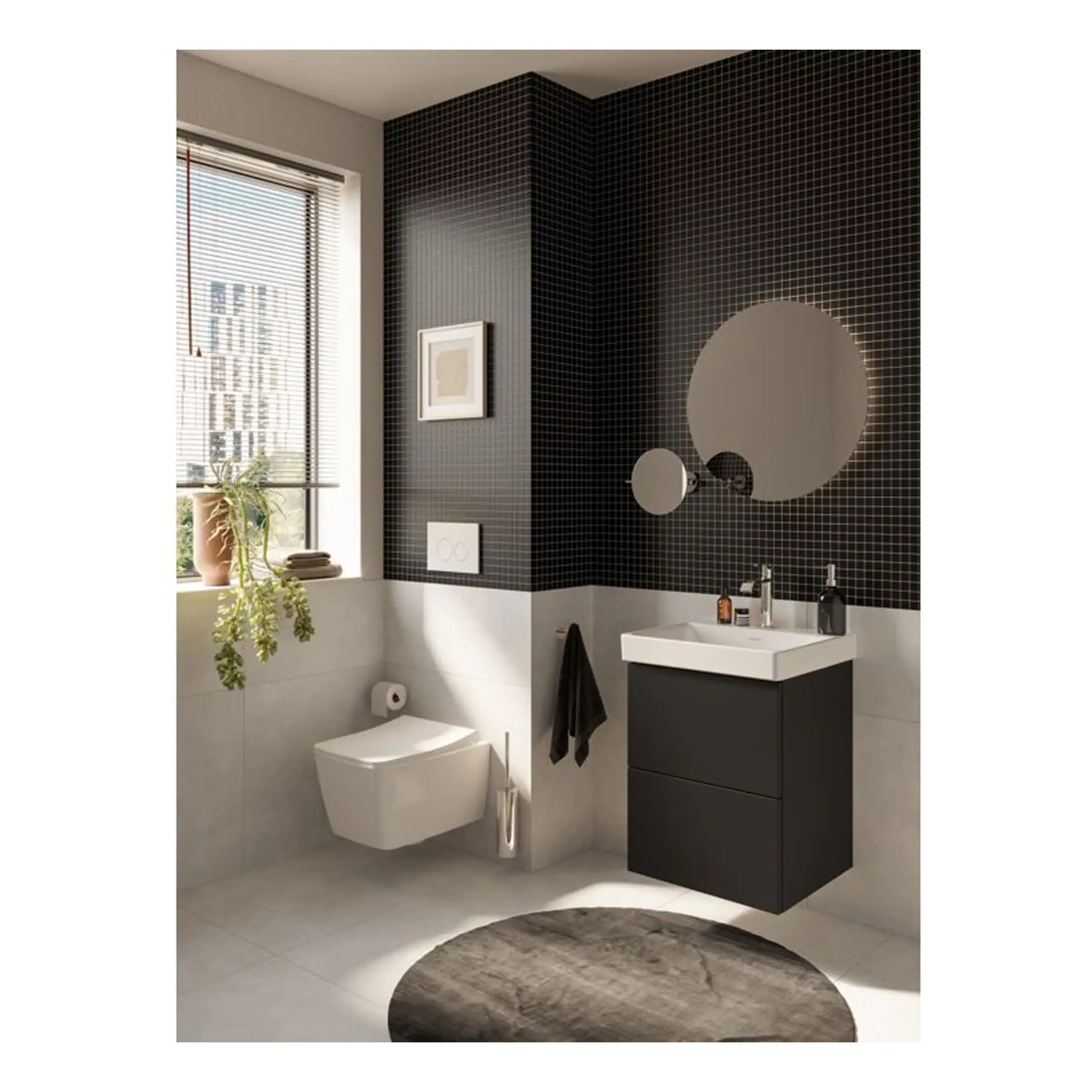 Modern black and white bathroom with floating toilet, minimalist vanity unit, circular mirrors, black mosaic tiles, and natural light from a large window, creating a stylish and contemporary look.