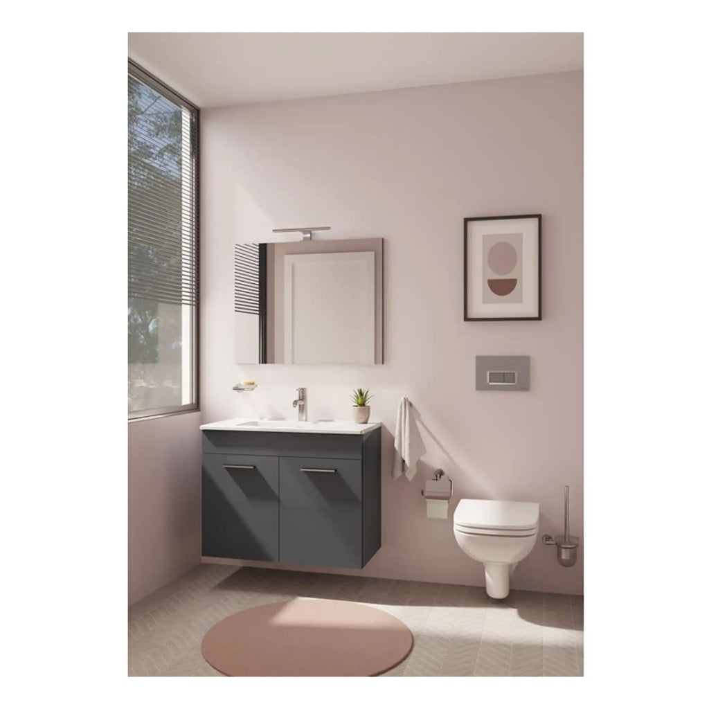Sleek modern bathroom with a grey vanity unit, wall-mounted toilet, large window with blinds, and minimalist decor creating a bright and stylish space.