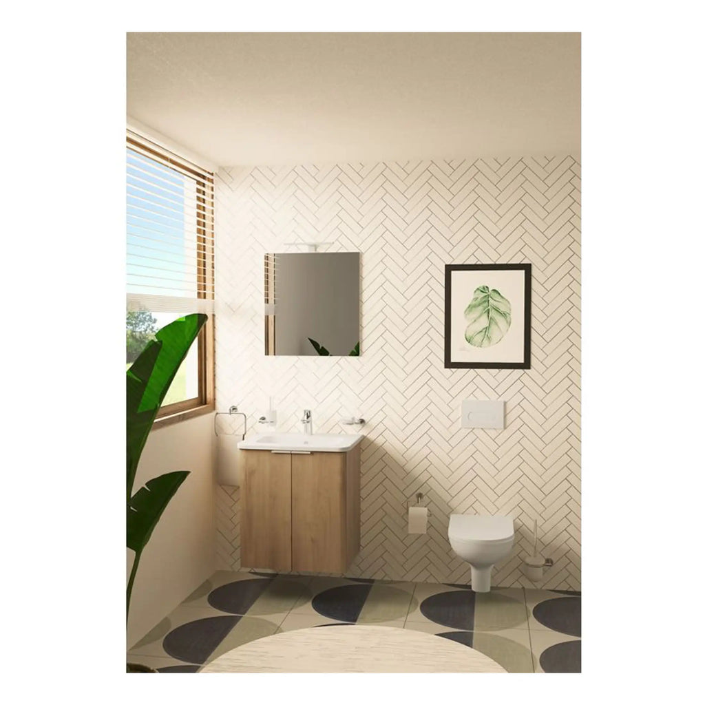 Modern minimalist bathroom with wooden vanity, wall-mounted toilet, framed botanical art, and geometric floor tiles, featuring natural light from a large window, ideal for contemporary bathroom renovations.