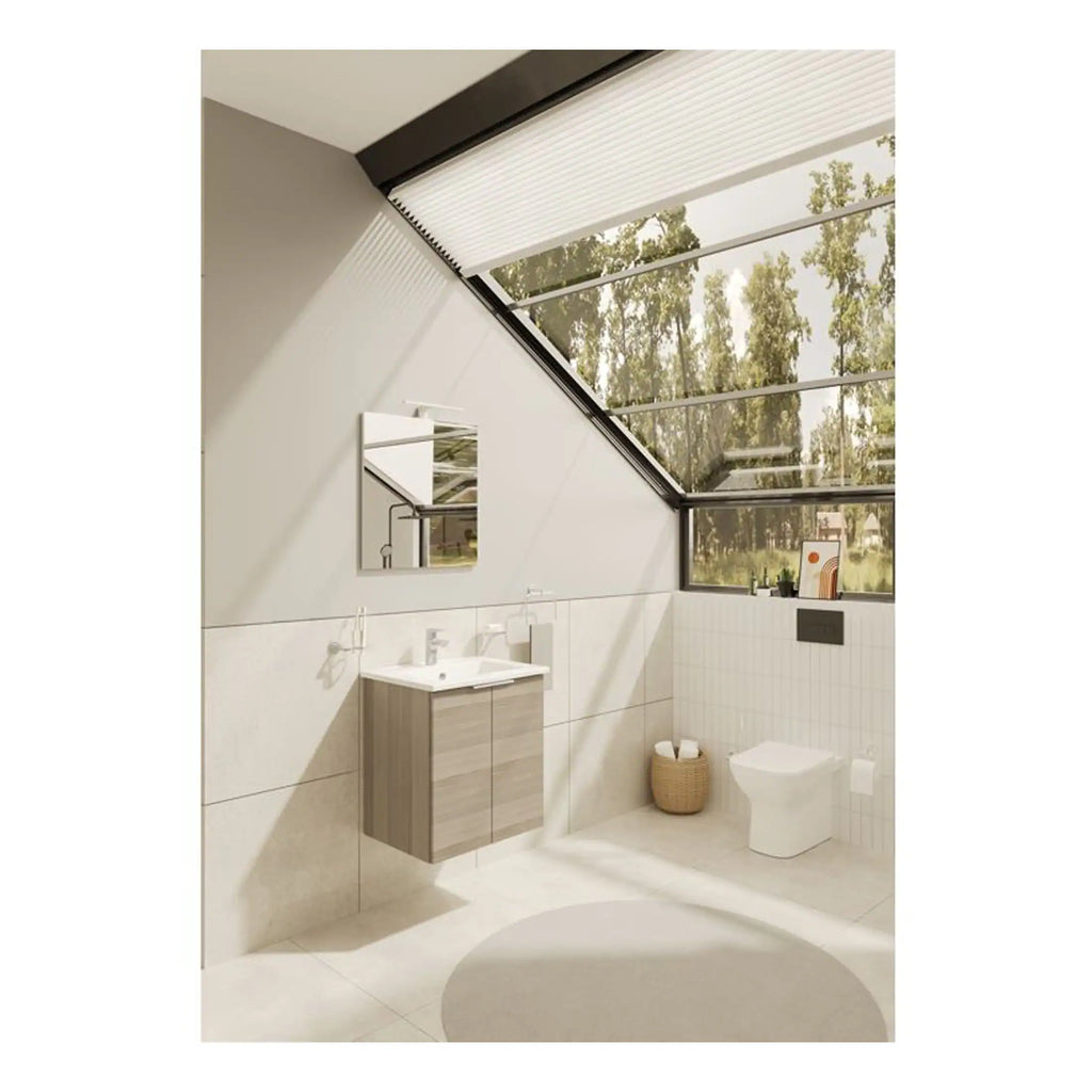 Modern bathroom with skylight, wall-mounted vanity with sink, toilet, and minimalist decor, creating a bright, airy space for comfort and style.