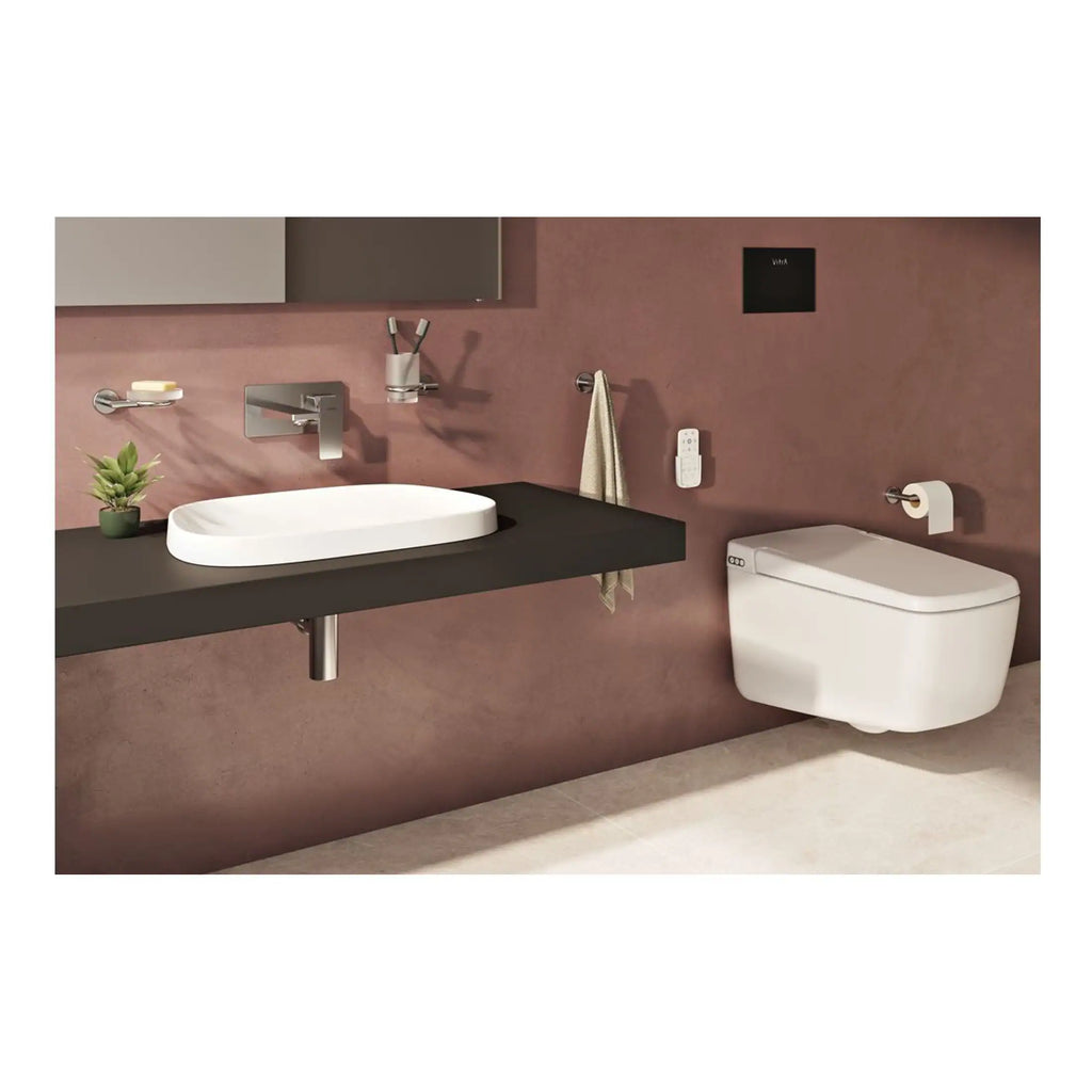 Sleek modern bathroom with wall-mounted toilet, minimalist sink, and contemporary fixtures, featuring a warm pink wall and stylish accessories for a luxurious bath design.