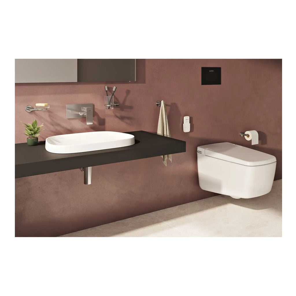 Sleek modern bathroom with a wall-mounted toilet, minimalist black vanity with vessel sink, wall-mounted faucet, and contemporary accessories in a stylish pink-toned space.