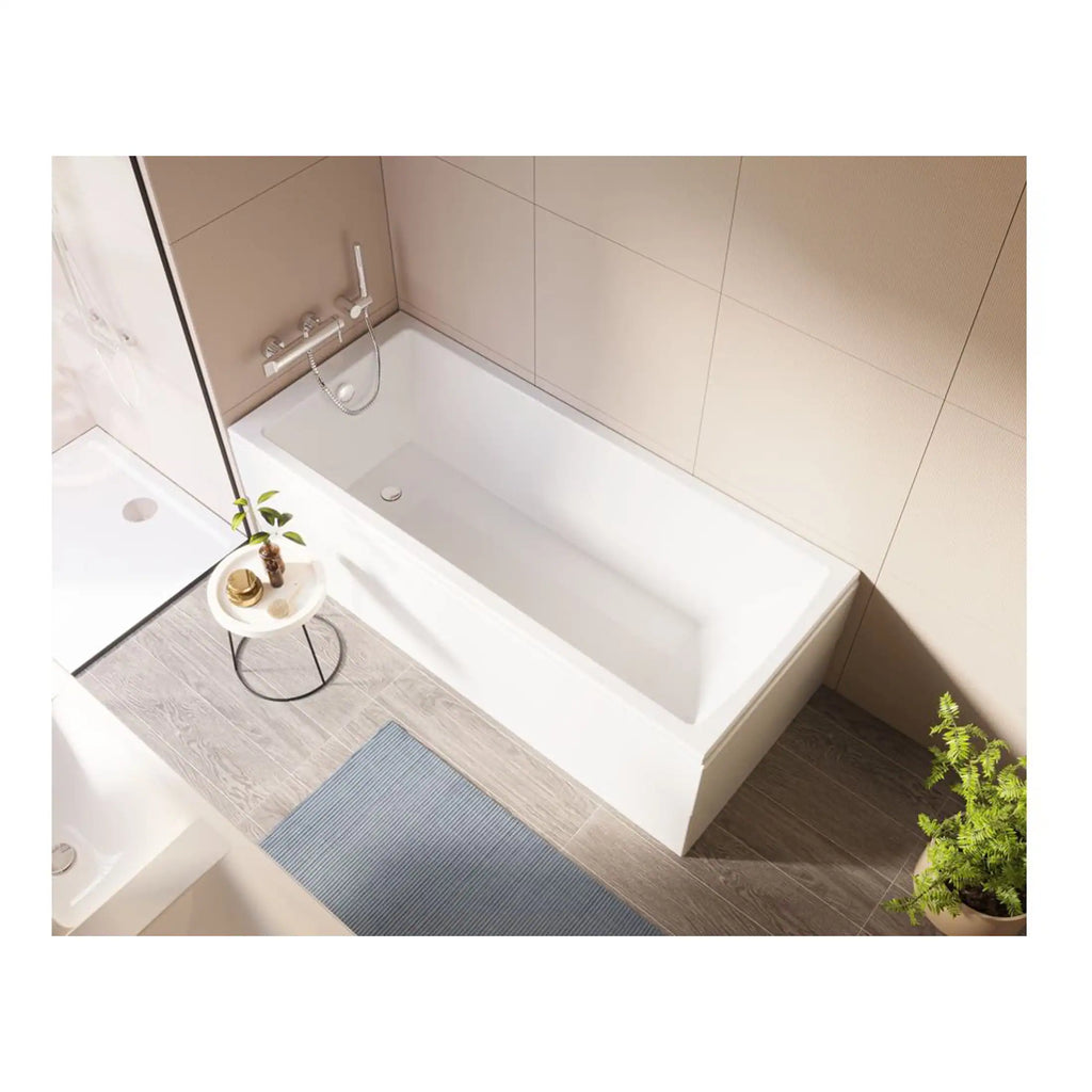 Modern white bathtub with sleek chrome fixtures in a contemporary bathroom with beige tiled walls. Perfect for relaxing baths, complemented by minimalist decor and natural elements for a stylish look.