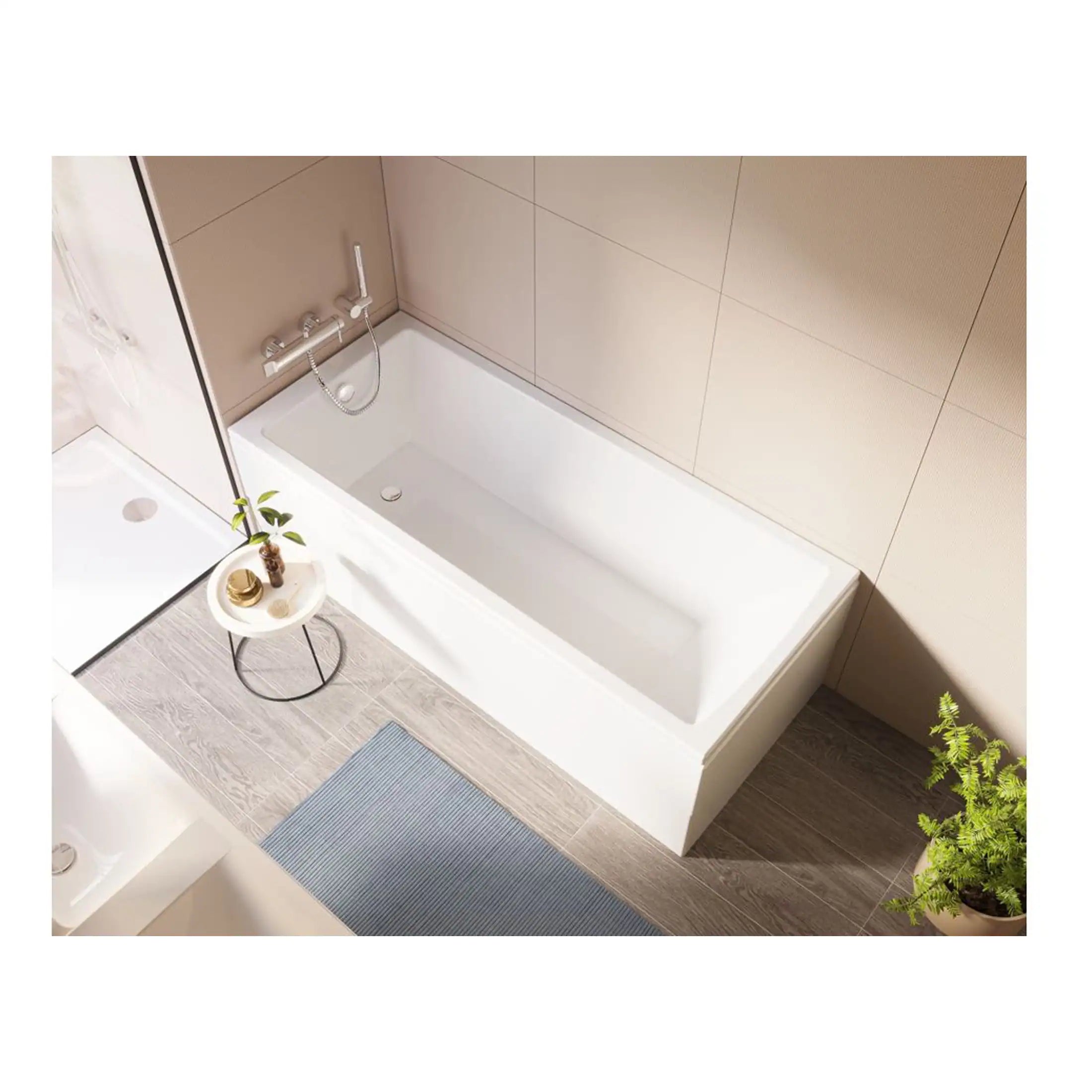 Modern white bathtub with sleek chrome fixtures in a contemporary bathroom with beige tiled walls. Perfect for relaxing baths, complemented by minimalist decor and natural elements for a stylish look.