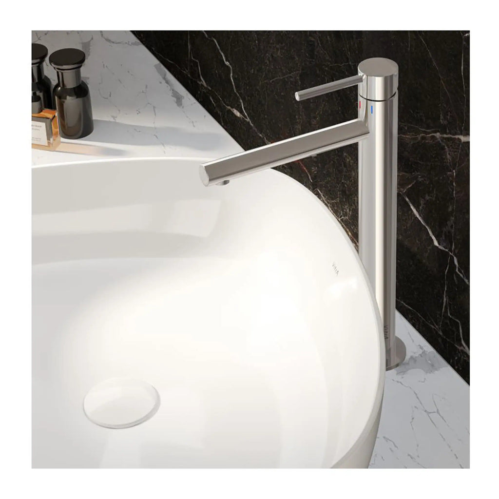 Sleek silver bathroom tap mounted on a white vessel sink with marble countertops and black marble wall accents. Perfect for modern Bubly bathrooms featuring contemporary fixtures and stylish design.