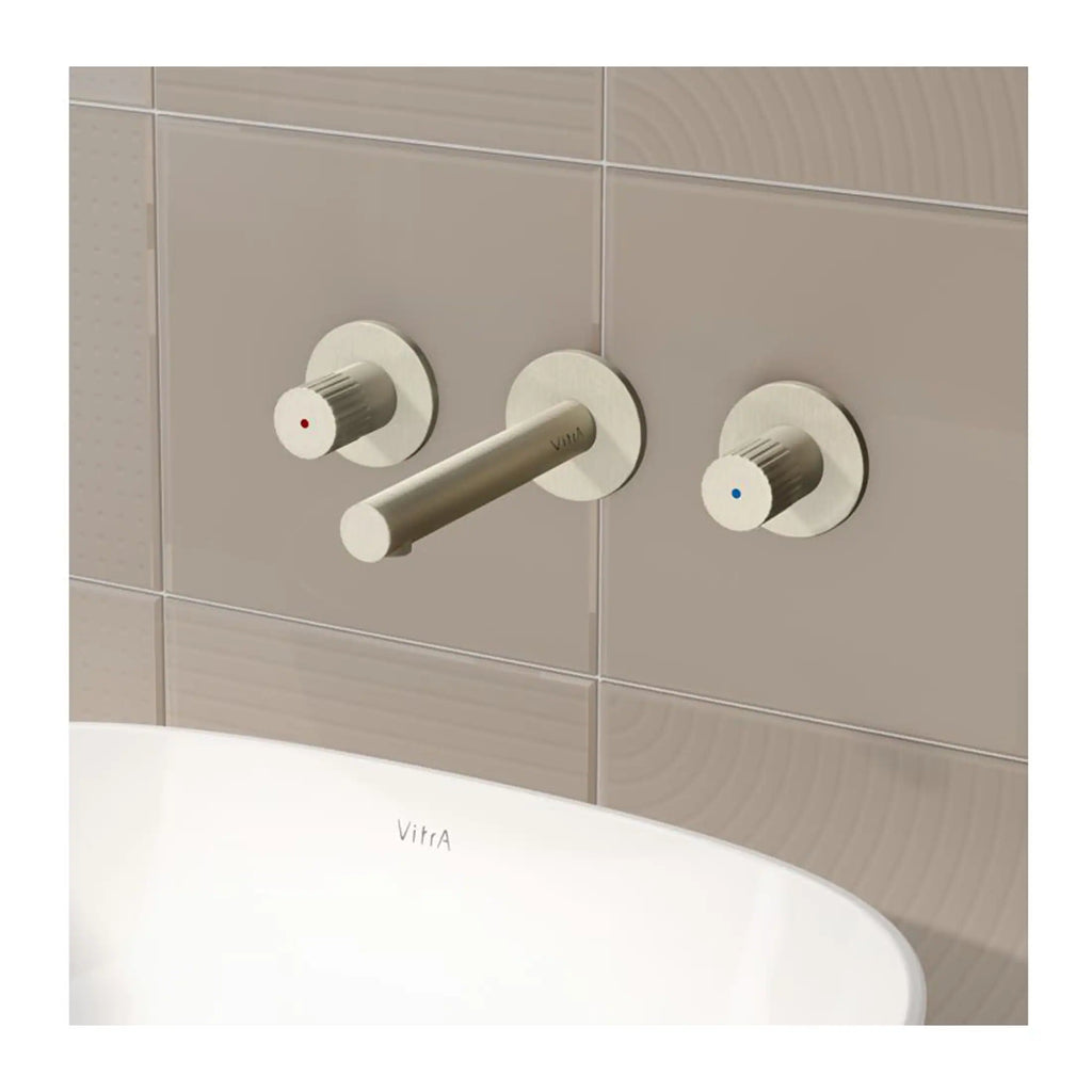 Sleek Vitra bathroom tap and control knobs with modern minimalist design, installed on beige tiled wall, combining functionality and contemporary style for elegant bathroom decor.