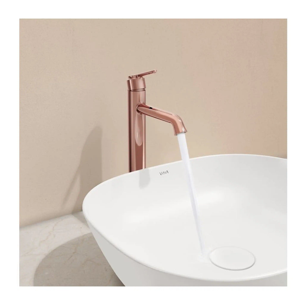 Sleek rose gold bathroom tap with modern design, filling a stylish white vessel sink in a contemporary bathroom setting.