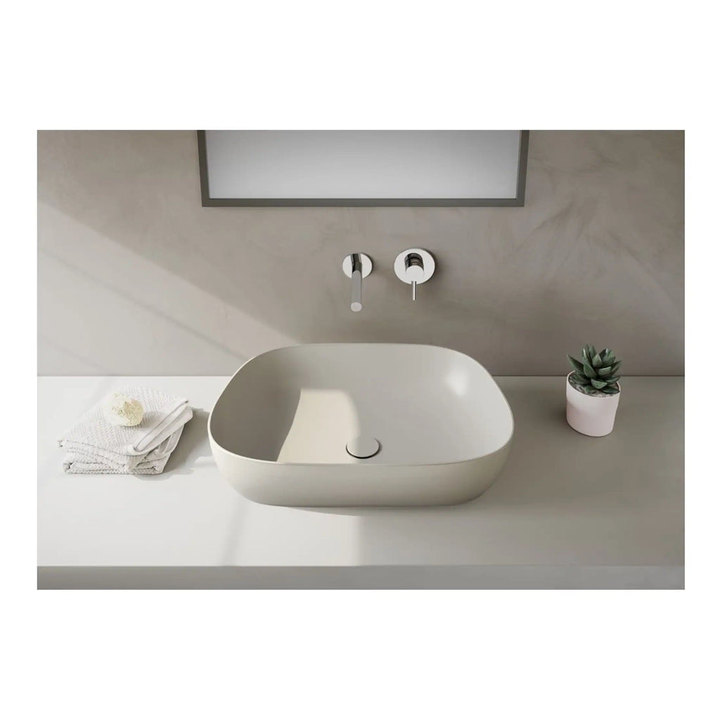 Sleek white bathroom vessel sink with modern wall-mounted tap and minimalist decor, ideal for contemporary bathroom design.