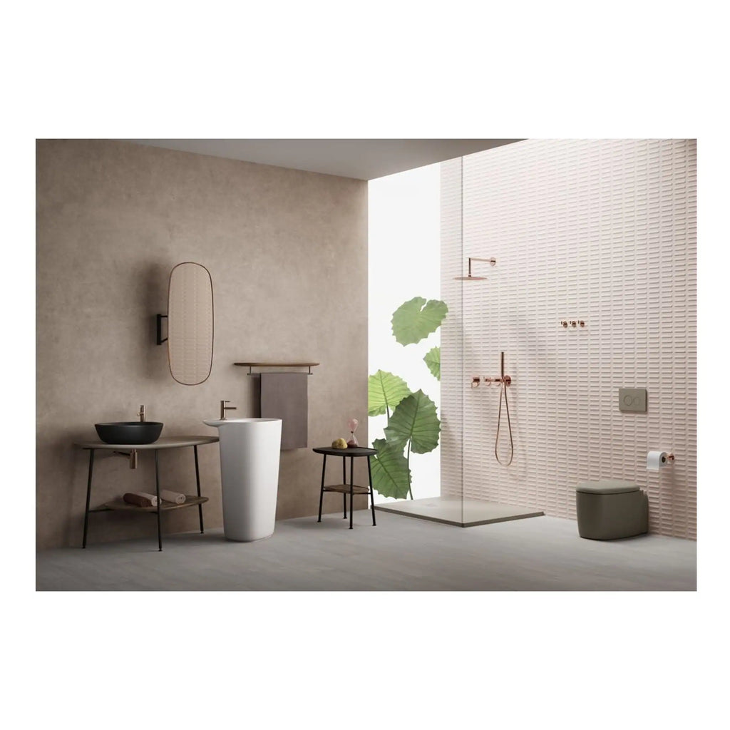 Elegant modern bathroom with minimalist fixtures, neutral tones, and stylish accents including a black basin, white pedestal sink, and a walk-in shower with rose gold fixtures.