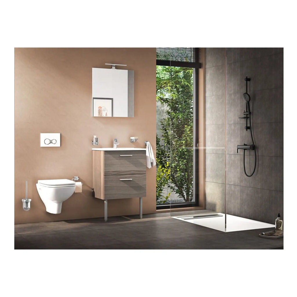 Modern bathroom with wall-mounted toilet, sleek vanity unit with sink, large mirror, and walk-in shower with dark tiles and glass partition, surrounded by greenery outside.