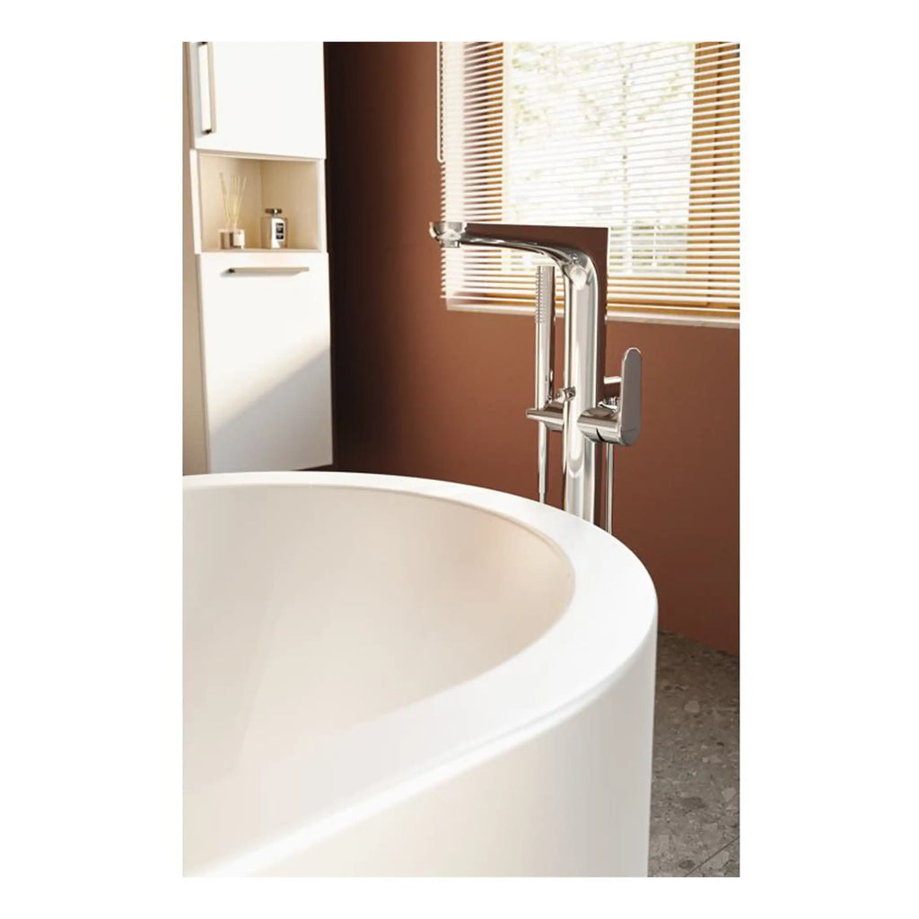 Elegant freestanding bathtub with modern chrome bathtub filler and hand shower, complementing contemporary bathroom design with wooden window blinds and warm wall tones.