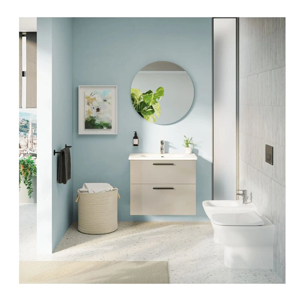 Sleek modern bathroom with light blue walls, wall-mounted vanity, round mirror, and contemporary fixtures, showcasing stylish bathroom design and decor.