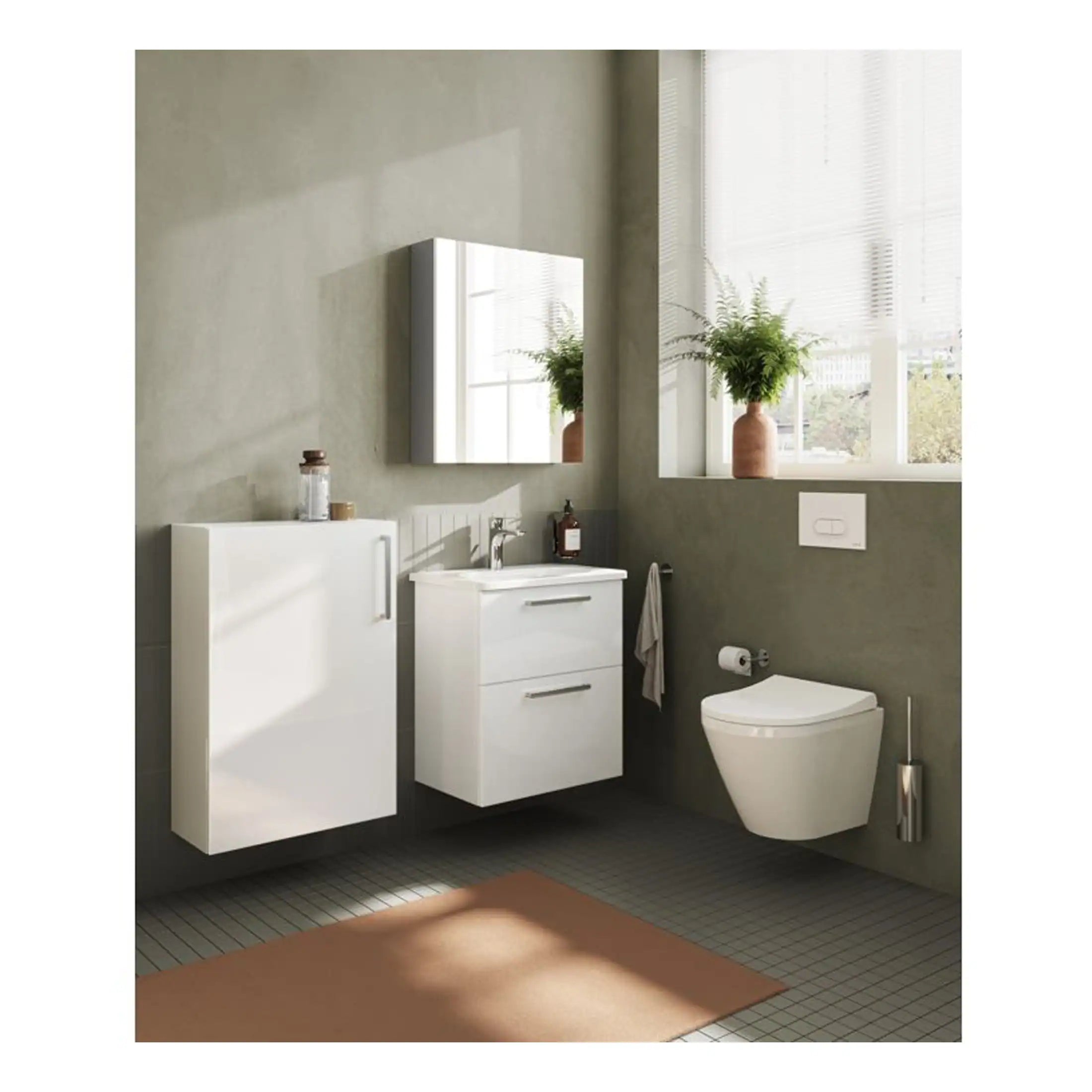 Sleek modern bathroom with minimalist white fixtures including wall-mounted vanity, cabinets, and a wall-hung toilet, complemented by natural light and green plants for a peaceful aesthetic.