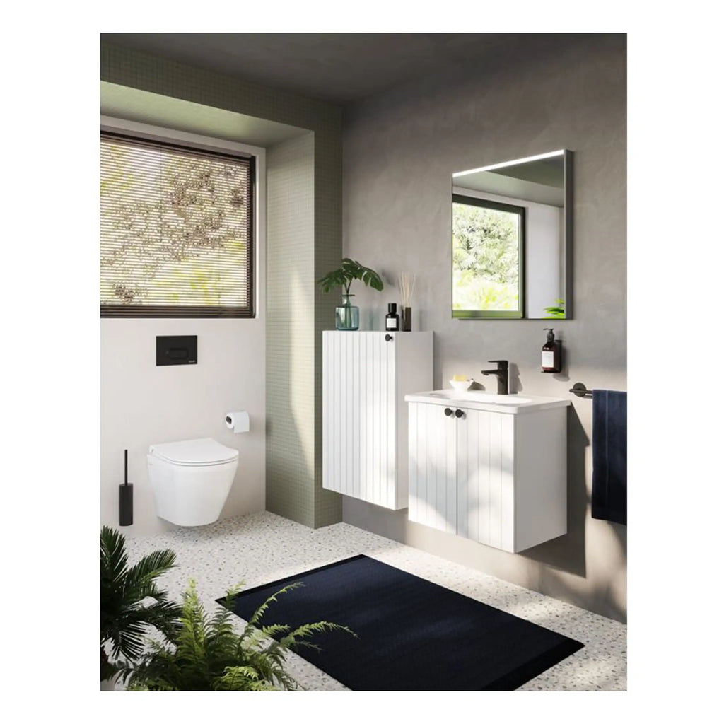 Contemporary bathroom featuring a wall-mounted toilet, sleek white vanity with black fixtures, modern mirror, and minimalist decor with natural light and greenery for a fresh, stylish look.