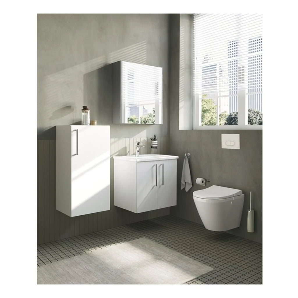 Modern white bathroom vanity unit with integrated sink and wall-mounted toilet in a minimalistic grey bathroom, featuring large windows and natural light, creating a sleek and contemporary look.