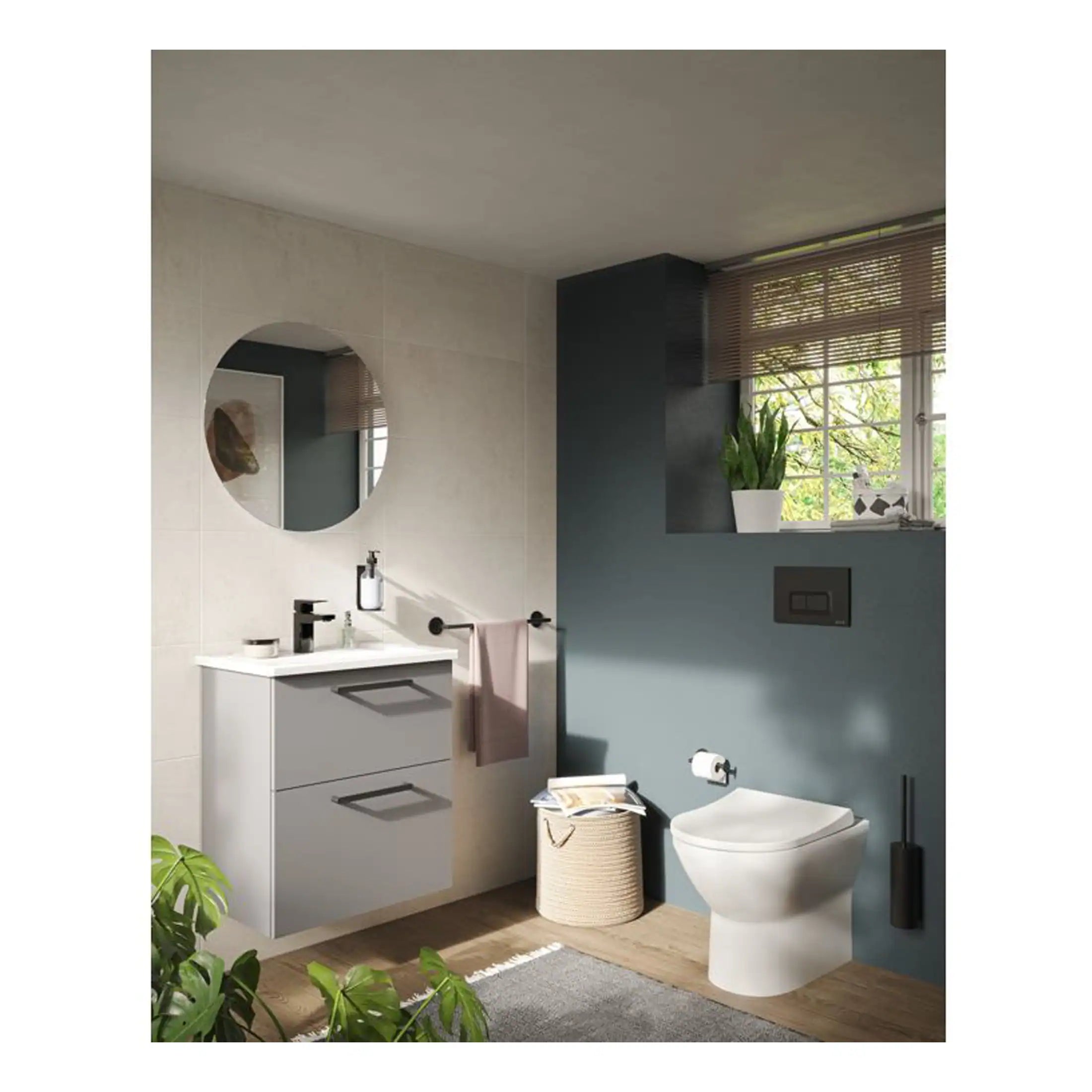 Sleek modern bathroom featuring a stylish wall-mounted vanity, round mirror, and wall-hung toilet with contemporary design, complemented by natural light and indoor plants for a relaxing vibe.
