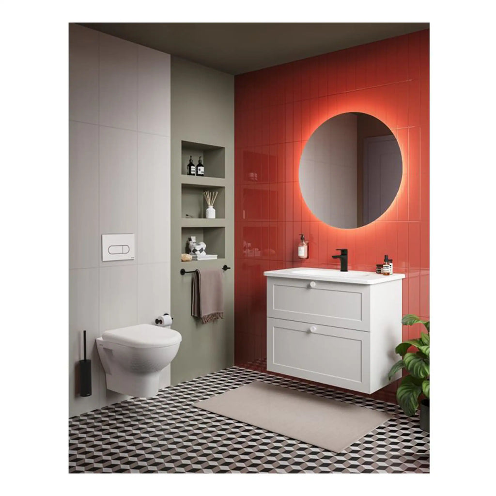 Sleek modern bathroom with white vanity, backlit round mirror, black fixtures, and bold red tiled wall creating a stylish and contemporary space.