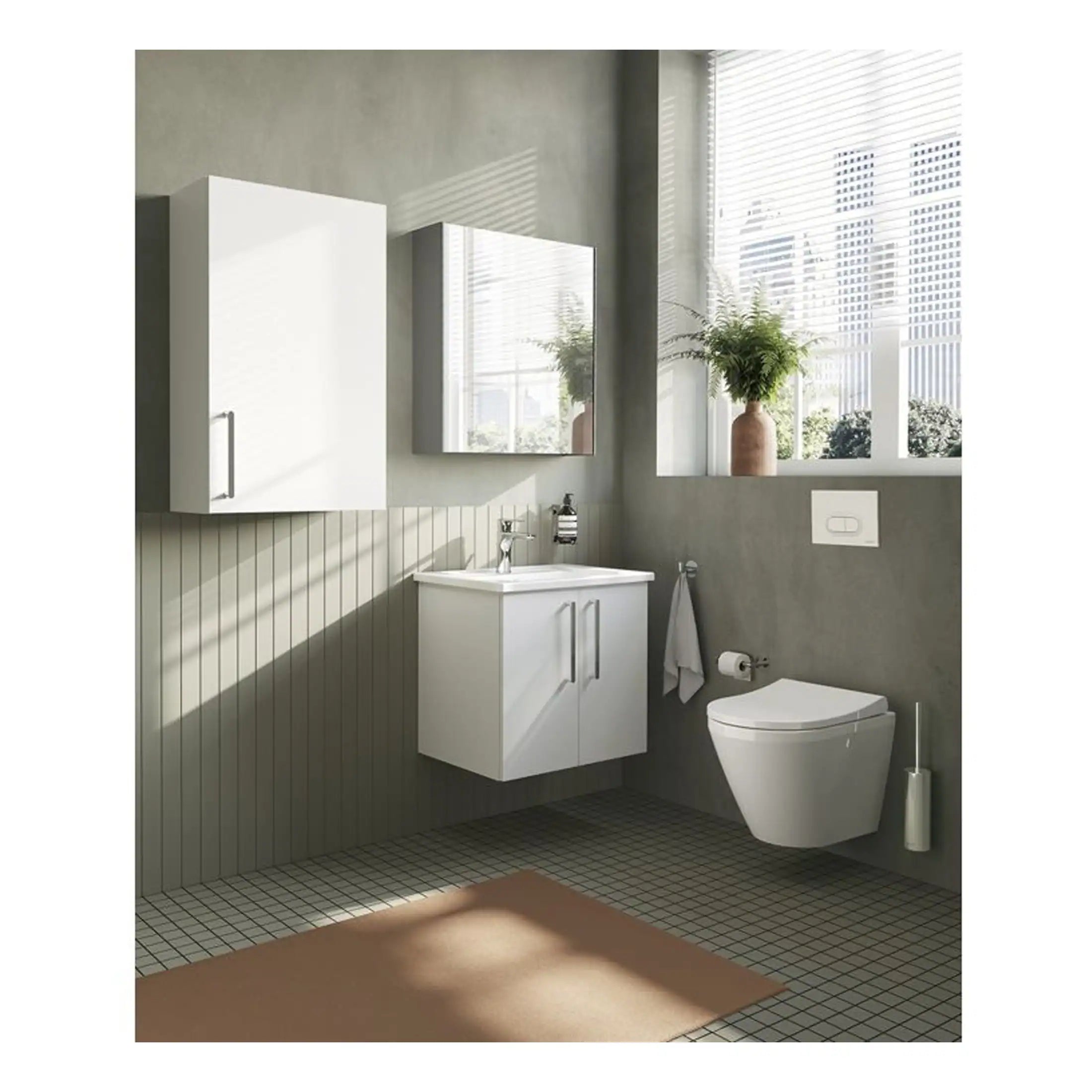 Modern white bathroom vanity with integrated sink and wall-mounted toilet in a minimalist bathroom setting with natural light.
