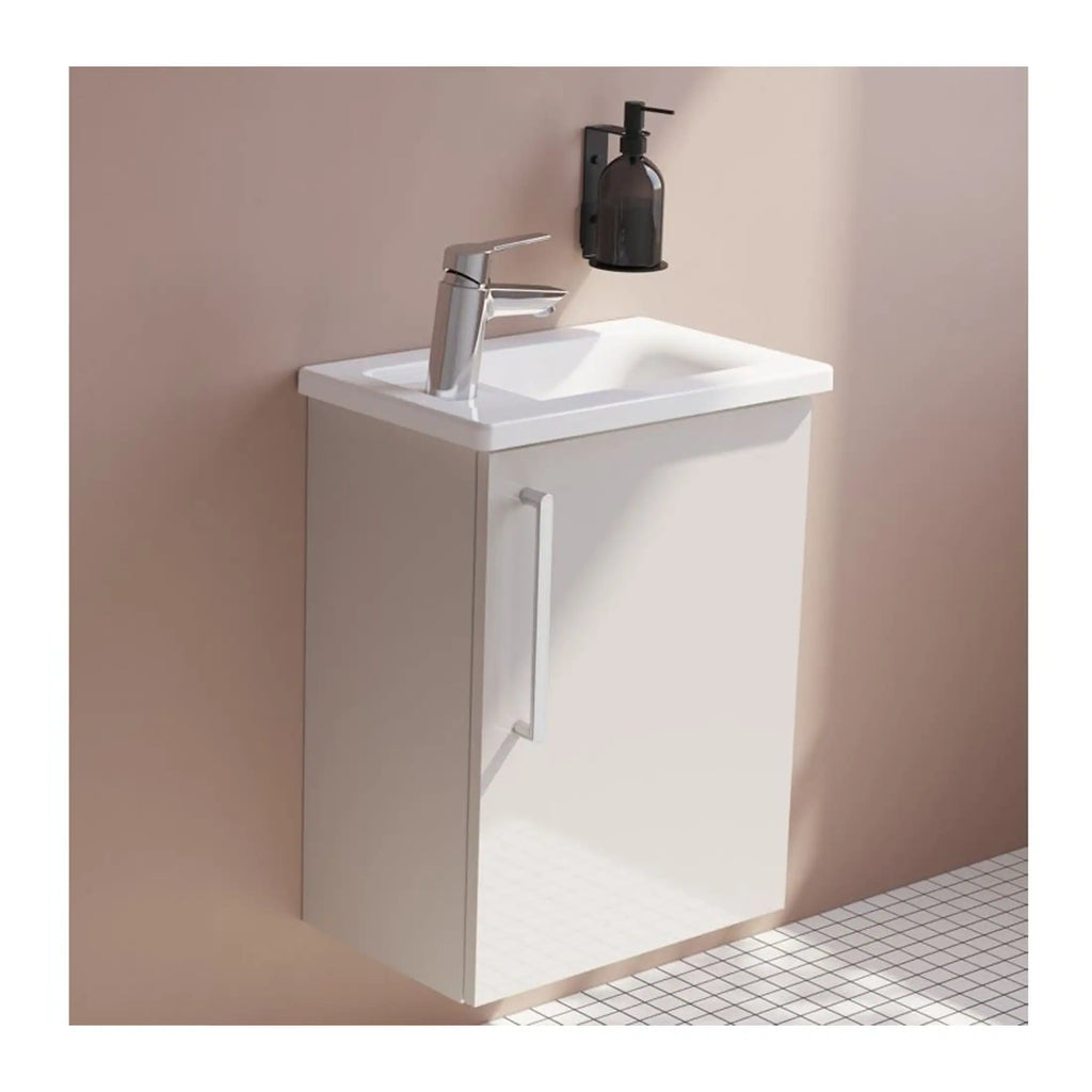 Compact bathroom vanity with integrated sink and modern tap, ideal for small spaces and contemporary bathroom designs. Features clean lines and functional storage.