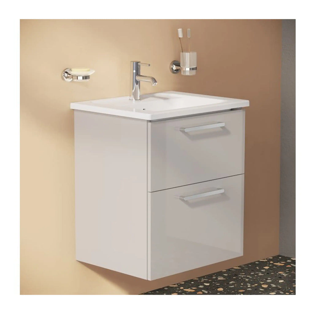 Modern white bathroom vanity with sink and chrome fixtures, beige wall background, ideal for contemporary bathroom renovations.