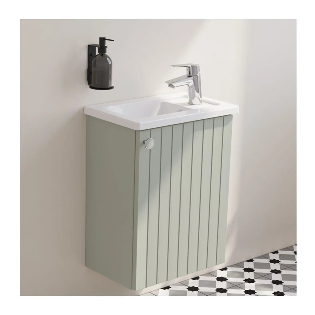 Contemporary bathroom sink with a sleek white ceramic basin mounted on a stylish light grey wooden vanity unit, above a patterned floor with black and white geometric tiles.
