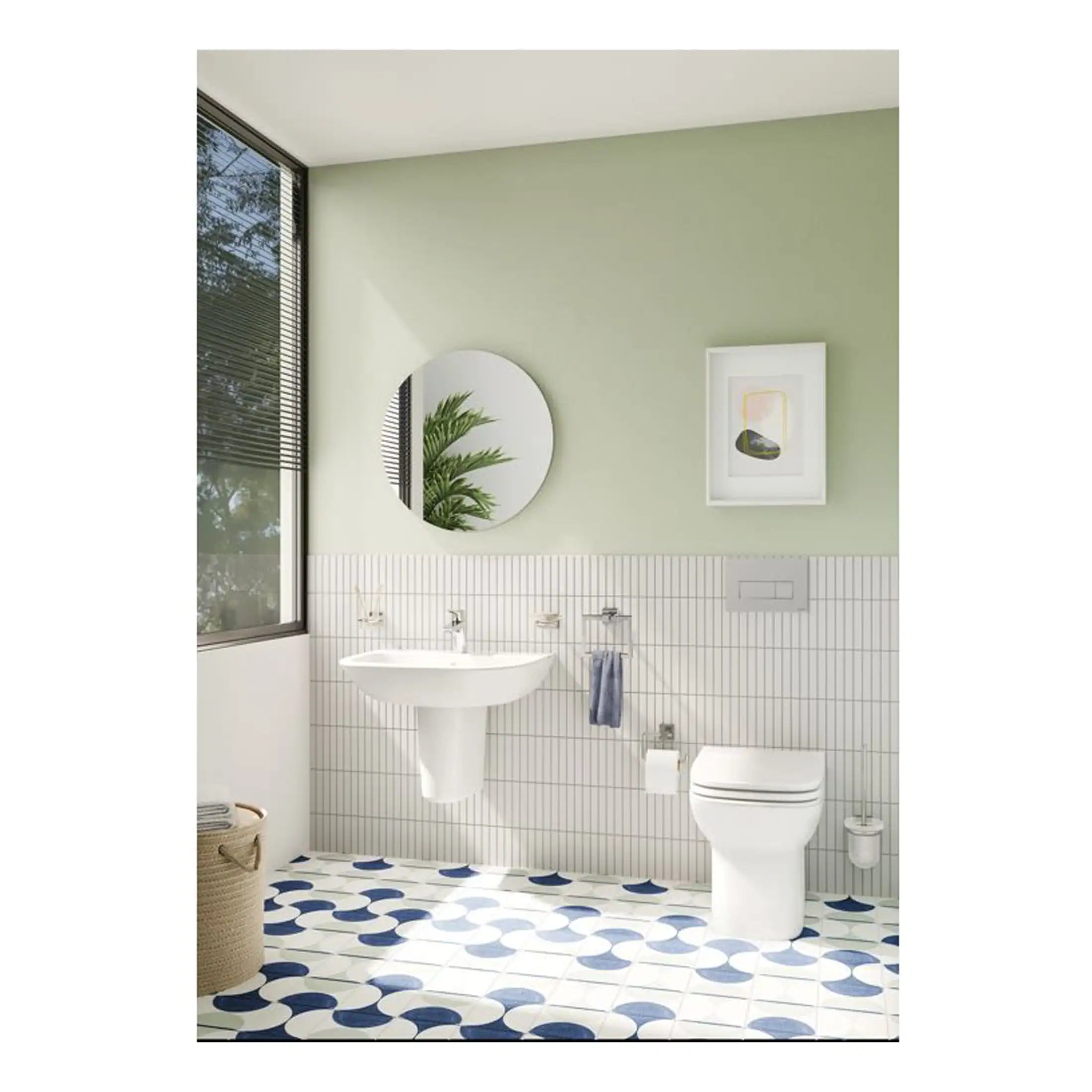Sleek modern bathroom with wall-mounted white sink, eco-friendly toilet, circular mirror, and contemporary artwork, featuring natural light and calming colour palette for stylish bathroom design.