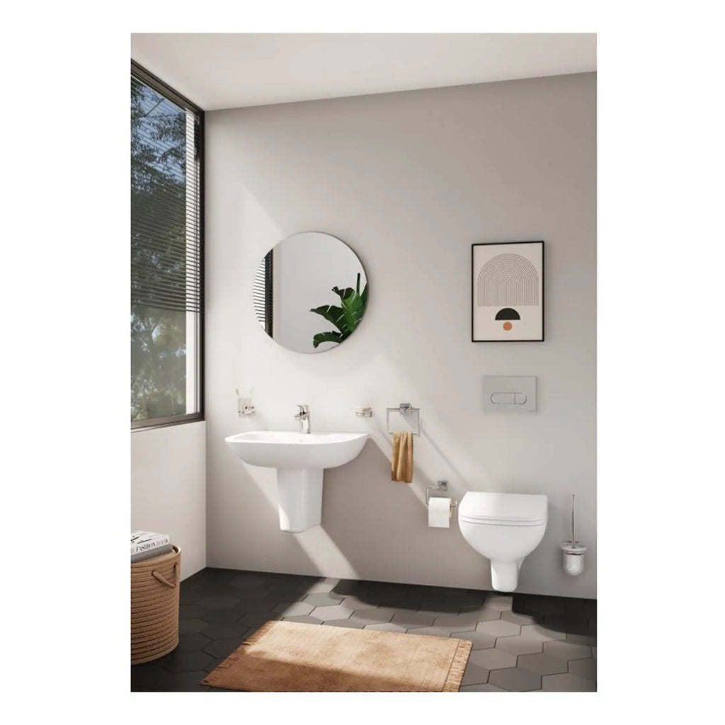 Contemporary minimalist bathroom with wall-mounted toilet, sleek sink, and modern decor, featuring natural light from large window, designed for style and functionality.